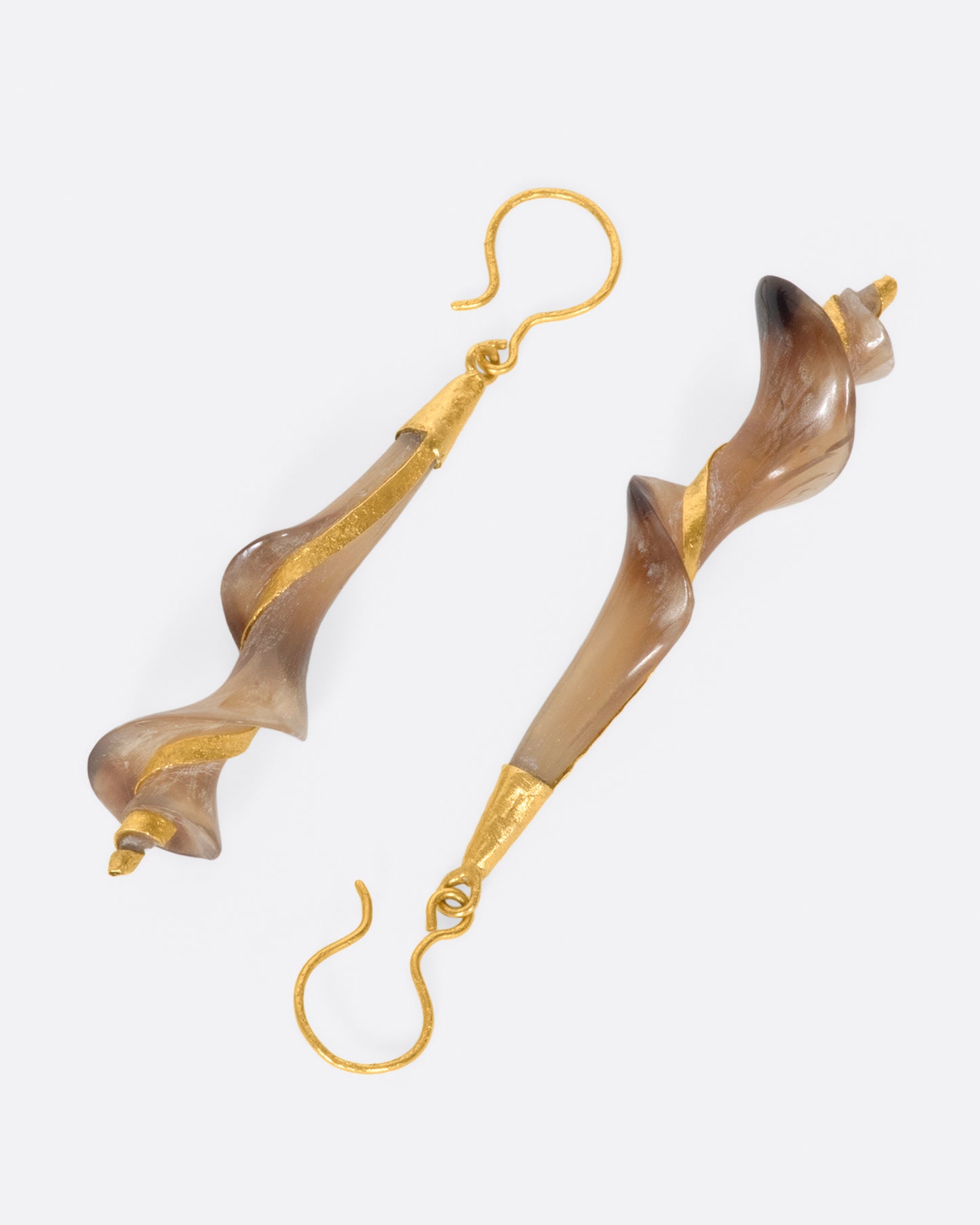 A pair of 22k yellow gold earrings with swirled brown horn drops.
