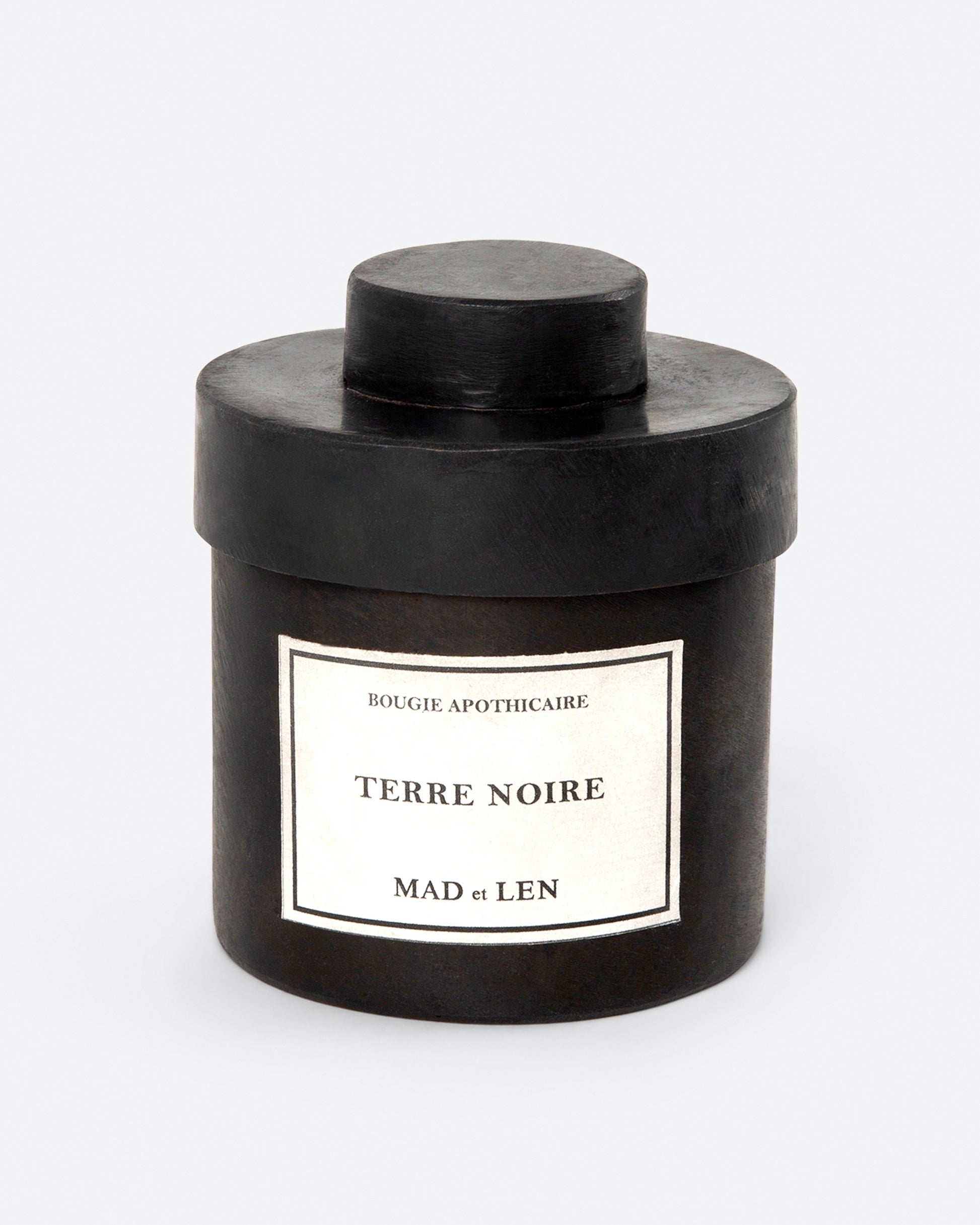 A Mad et Len Terre Noire candle shown from the front.