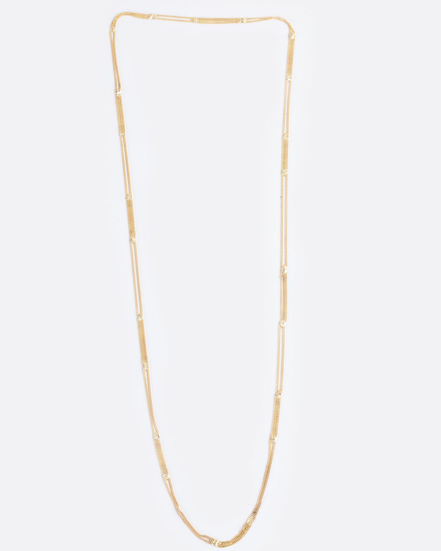 A long yellow gold multi chain necklace with alternating pattern of squares finished with gold solder. Shown from the front.