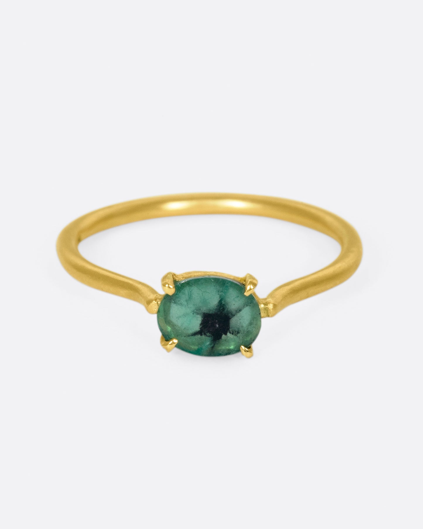 A simple solitaire ring with a glorious oval emerald.