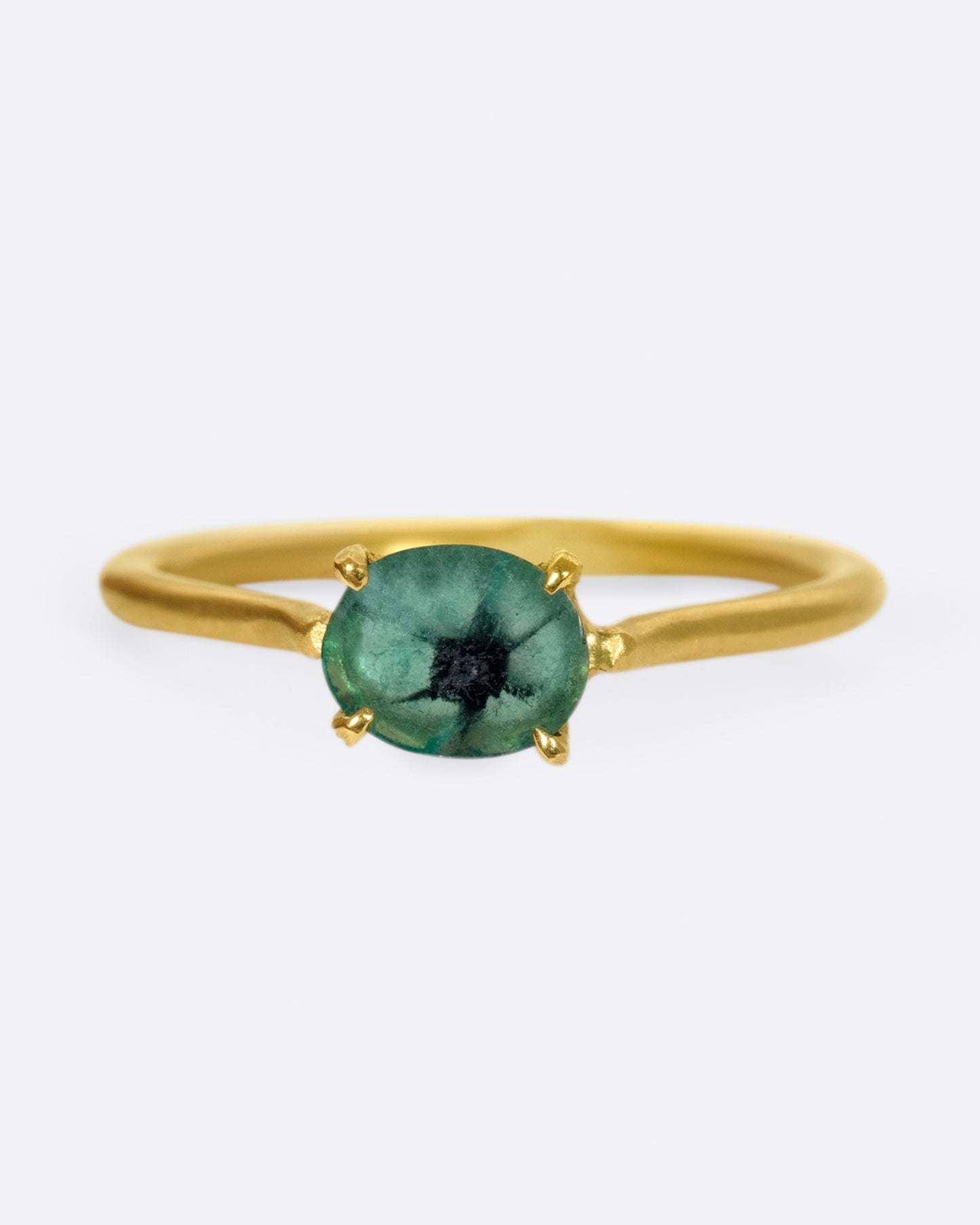 A simple solitaire ring with a glorious oval emerald.