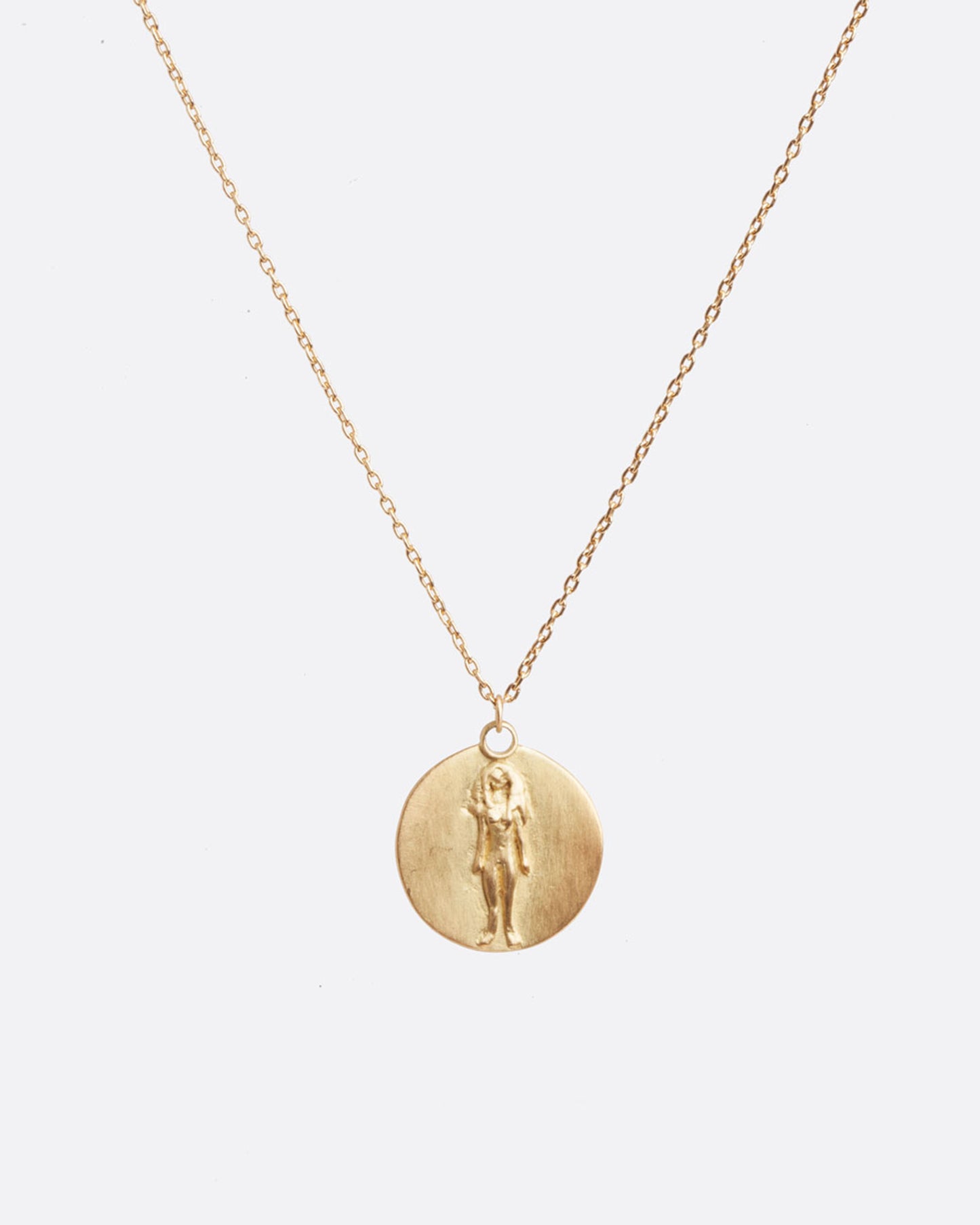 A yellow gold necklace with a round pendant with your choice of zodiac symbol.