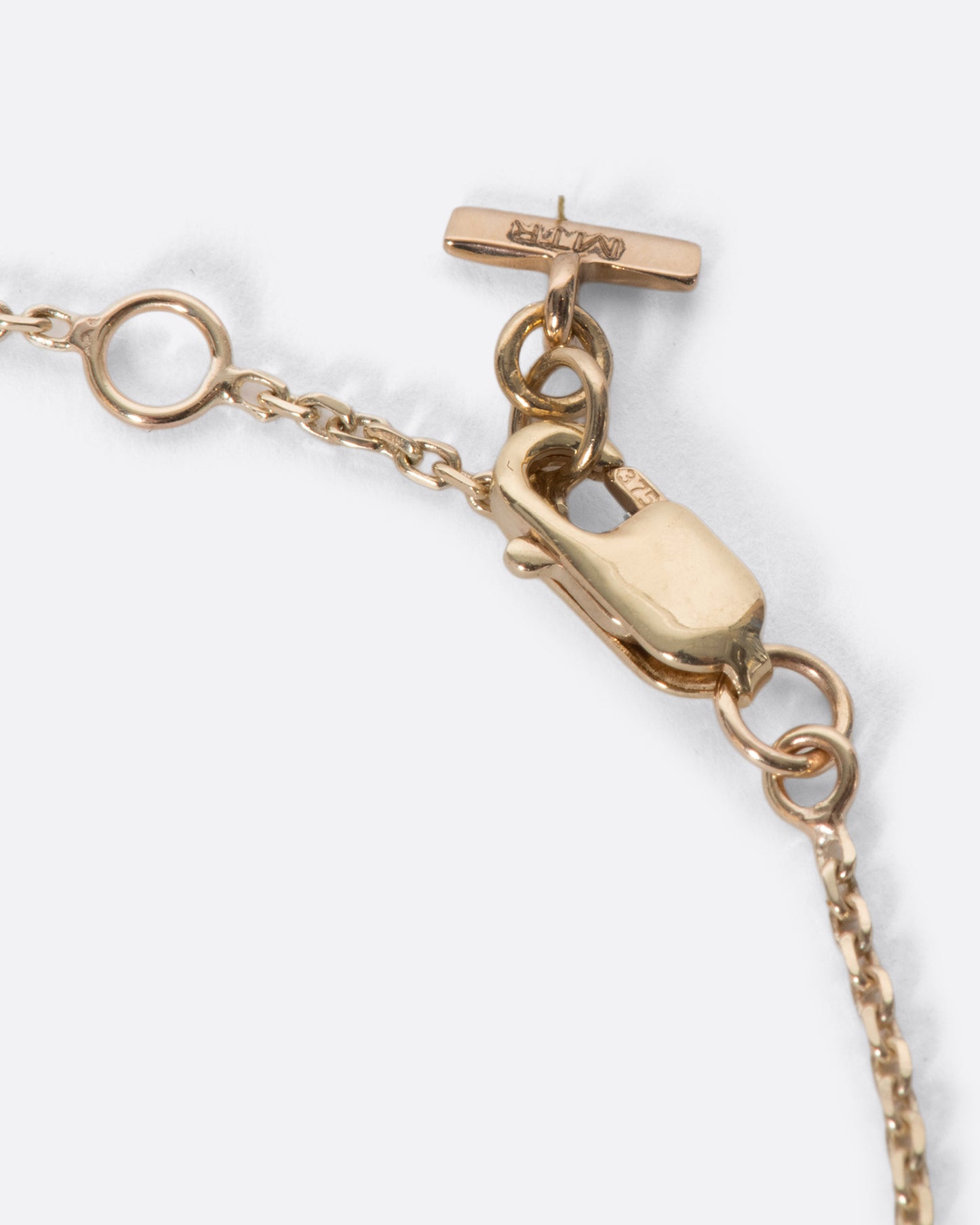 A precious candy apple red enamel heart on a fine gold chain bracelet