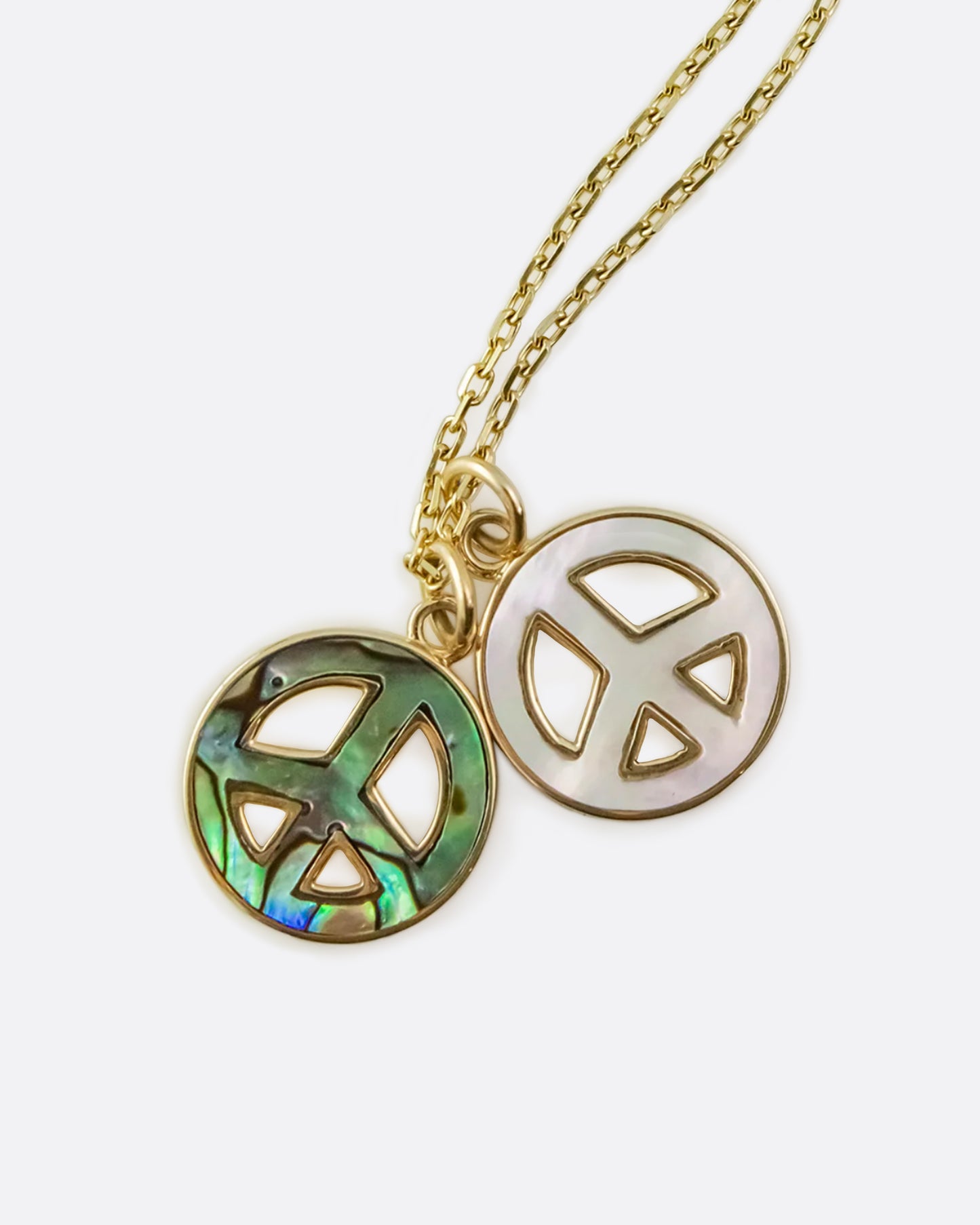 Abalone and mother of pearl peace sign pendants on a long, diamond cut chain.