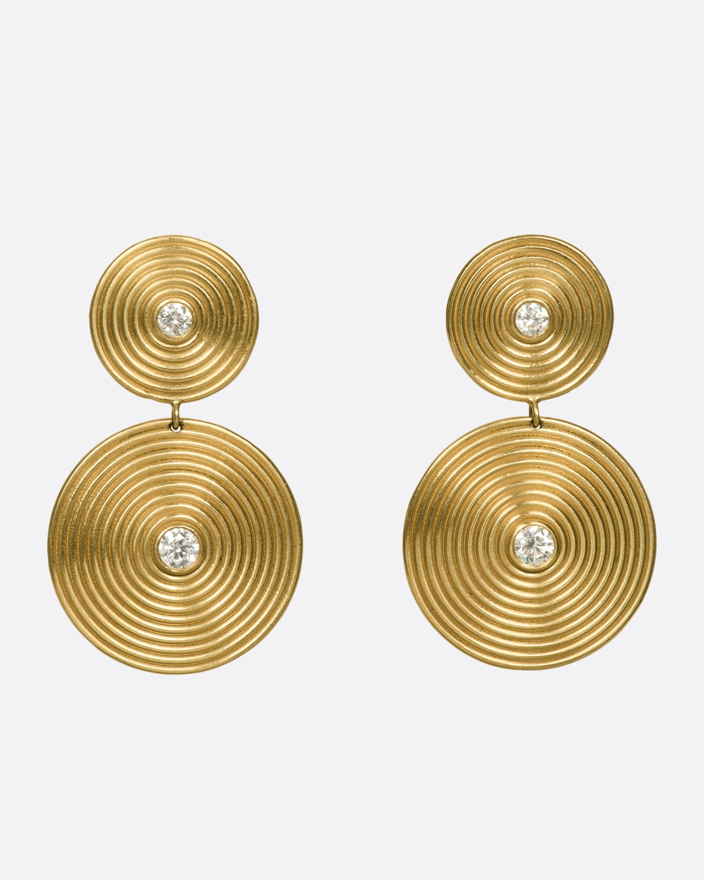 14k gold disc drops, each punctuated with two white diamonds. The concentric circles are elegant symbols of growth and change.