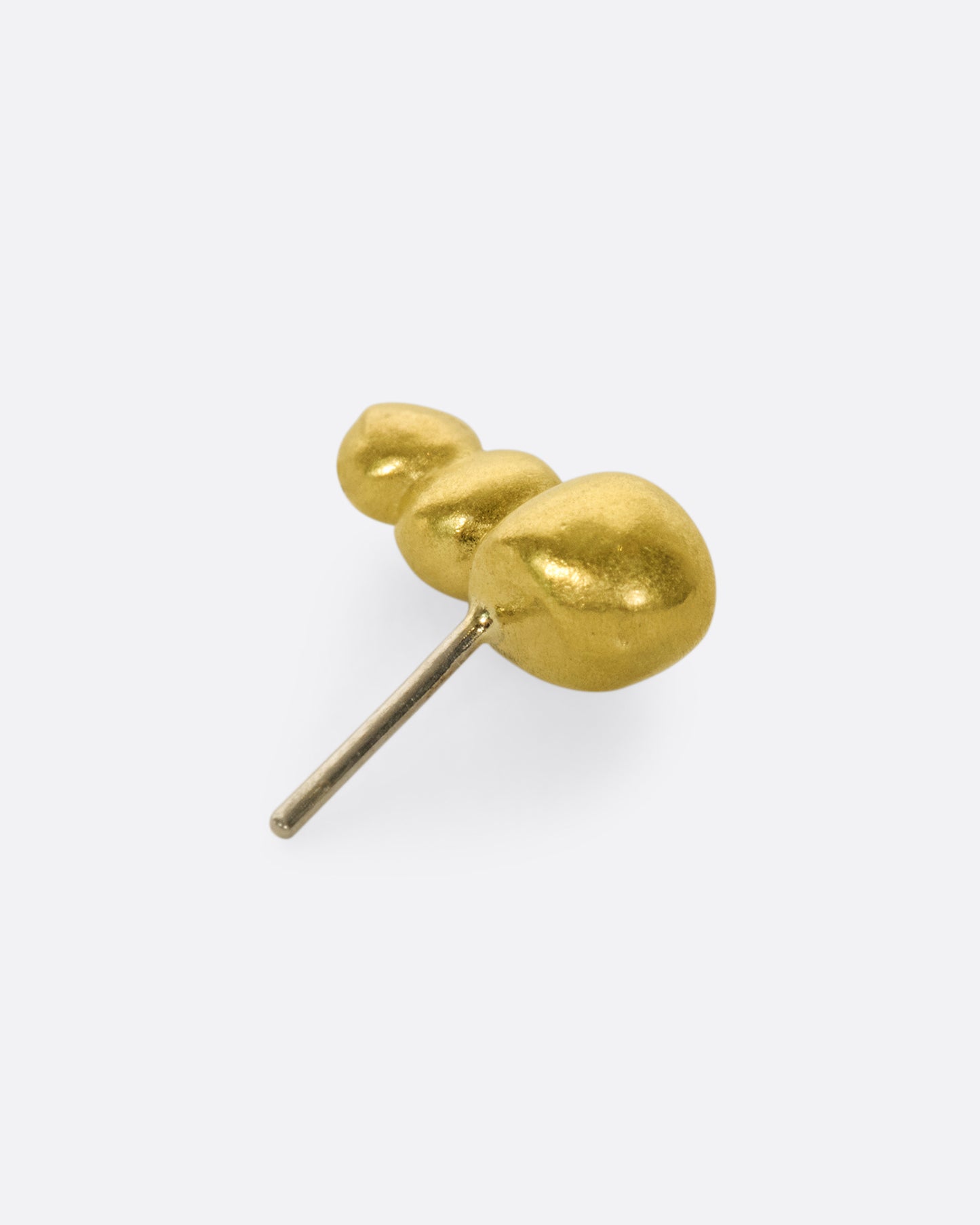 This high karat gold stud is perfect to tuck into little curves in the ear.