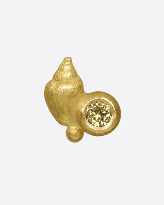 A matte gold sea shell accented by a pale yellow diamond.