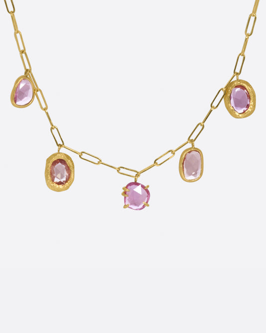 An oval link chain necklace with five rose cut sapphires, each in its own unique setting.