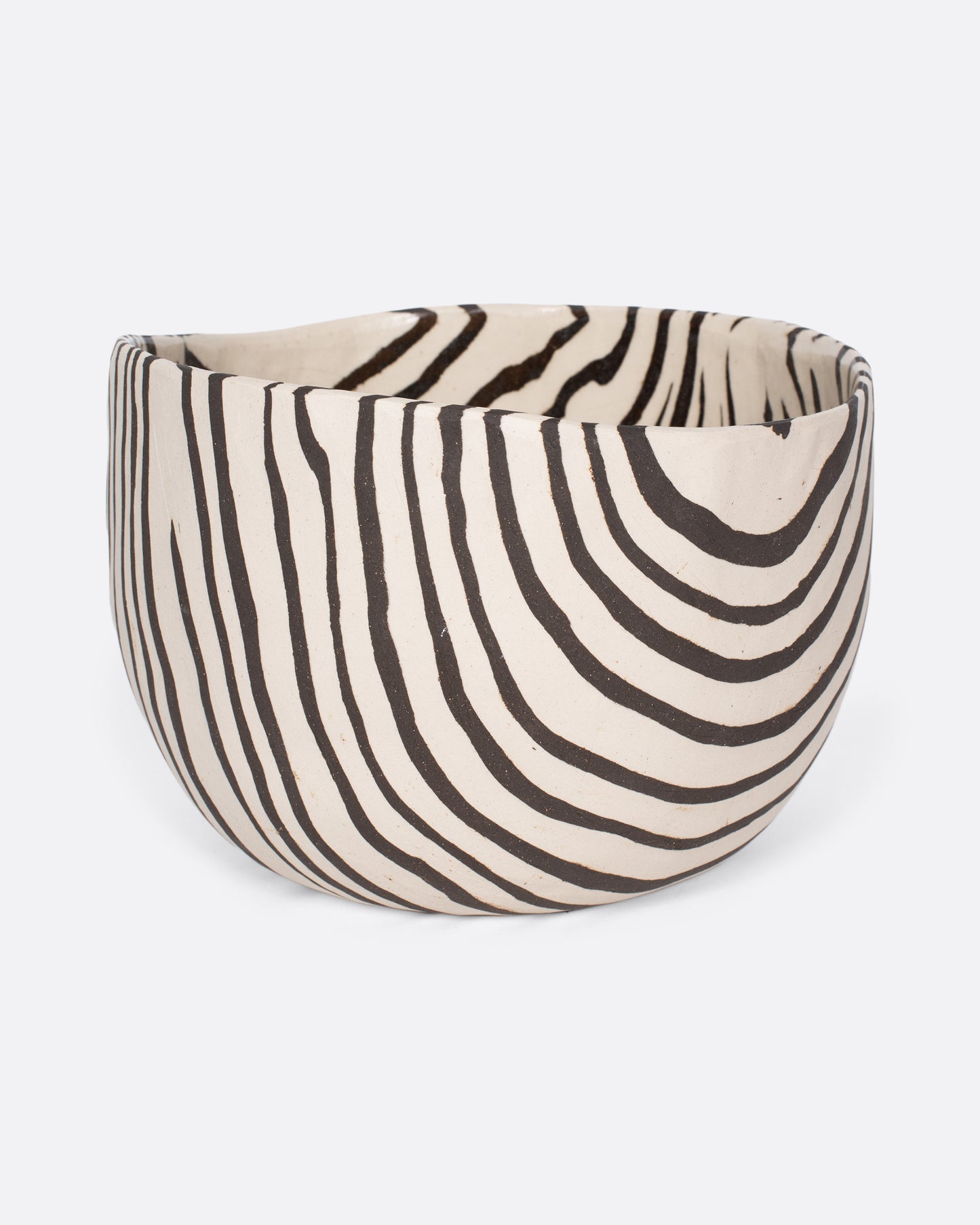 These small-batch ceramic bowls are made with a traditional Japanese Nerikomi technique that creates an intricate, marbled design by layering and compressing clay. Each bowl has a unique, zebra-striped design that feels other-worldly and timeless. Available in small, medium, and large sizes.