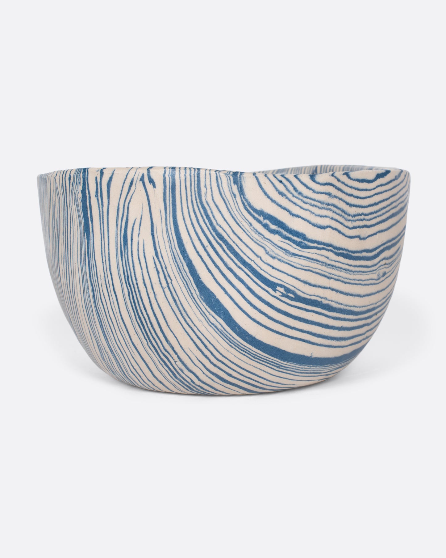 These small batch ceramic bowls look plucked straight from the ocean, with flowing hues of blue and white. They're made with a traditional Japanese Nerikomi technique that creates an intricate, marbled design by layering and compressing clay. Available in small, medium, and large sizes.