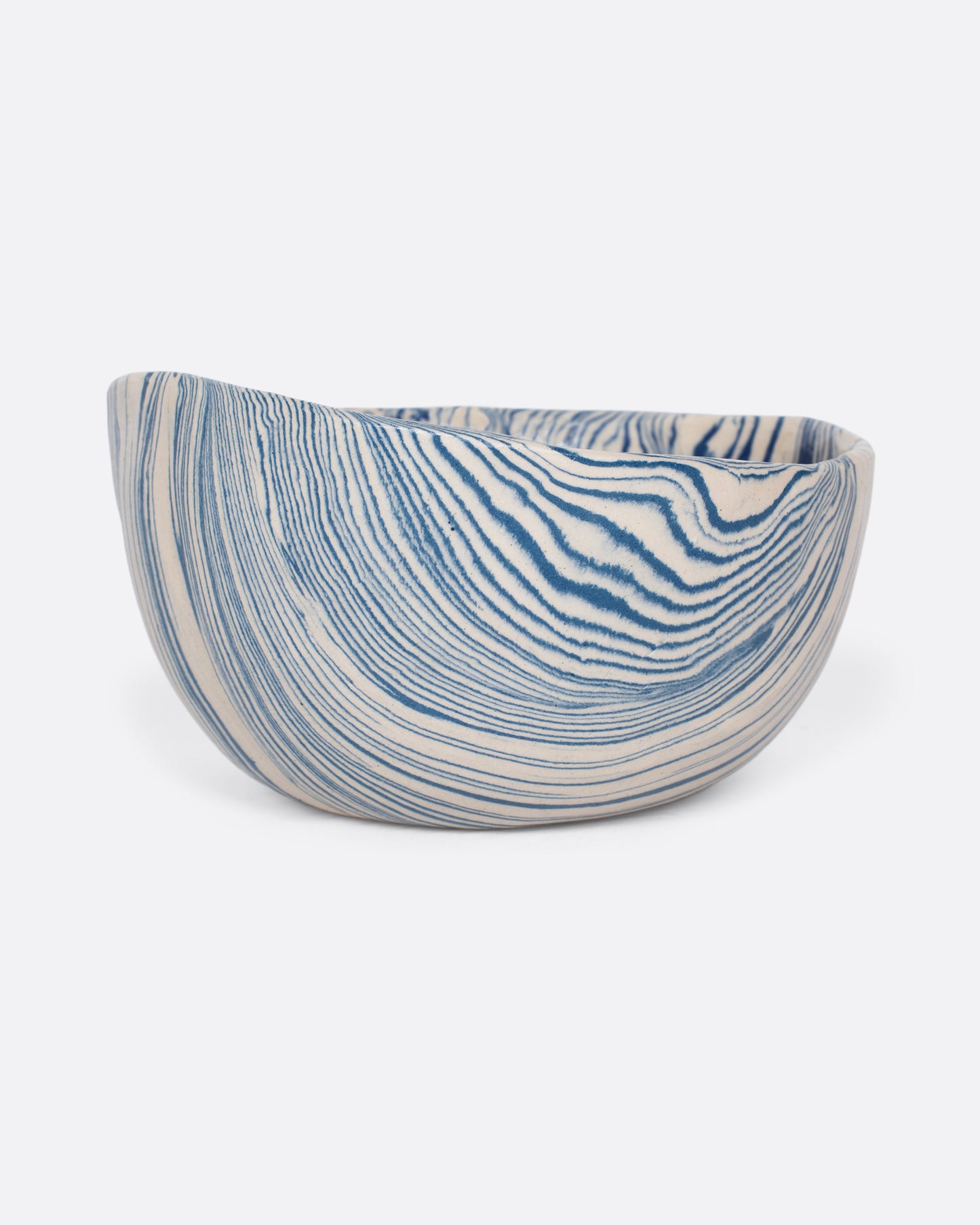 These small batch ceramic bowls look plucked straight from the ocean, with flowing hues of blue and white. They're made with a traditional Japanese Nerikomi technique that creates an intricate, marbled design by layering and compressing clay. Available in small, medium, and large sizes.