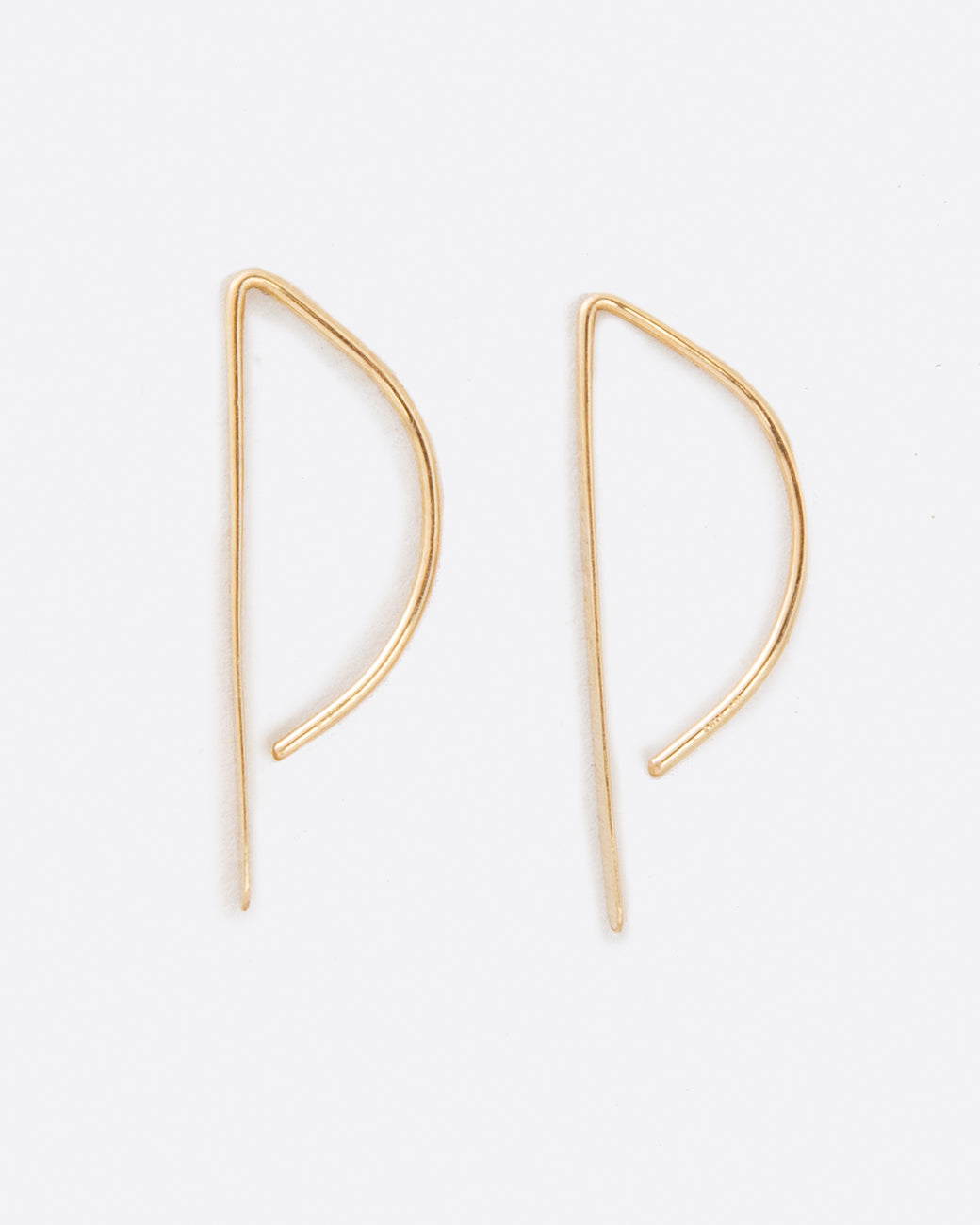 An unusual take on a hoop earring with a flat edge that catches the light.