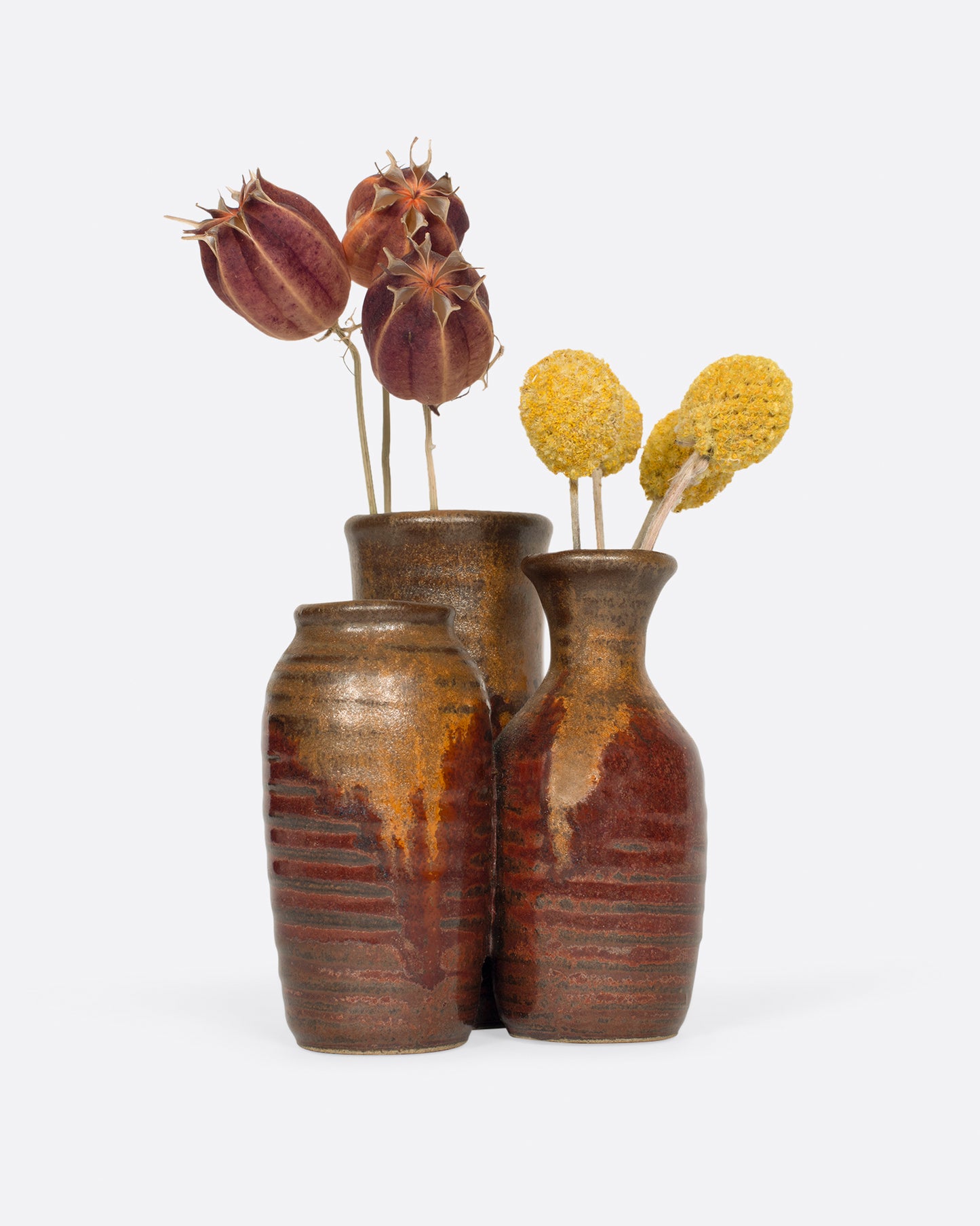 A group of three tiny vases, connected as one.