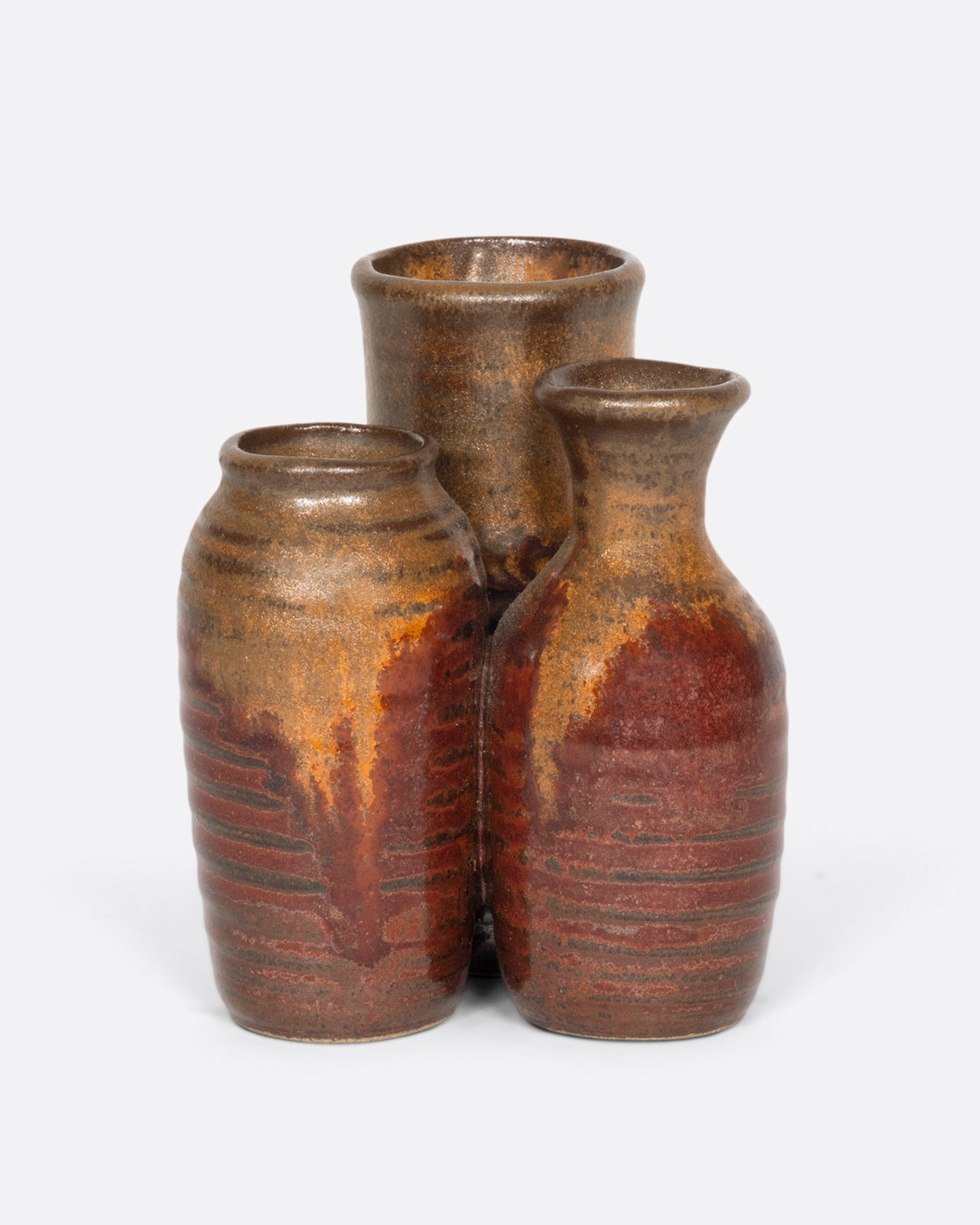 A group of three tiny vases, connected as one.