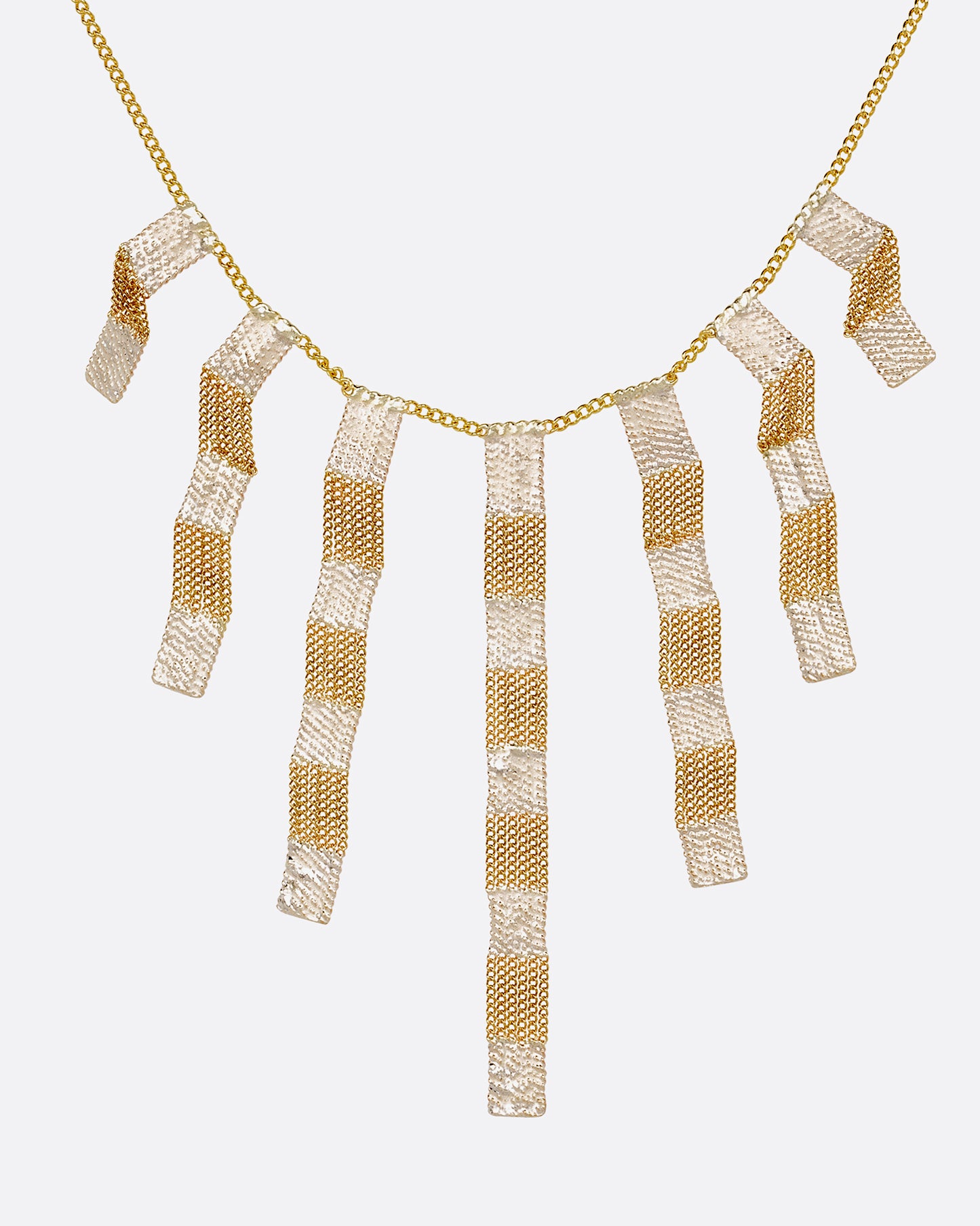 A yellow gold cable chain necklace with seven clusters of cable chain fringe with alternating bits of silver solder. Shown from the front.
