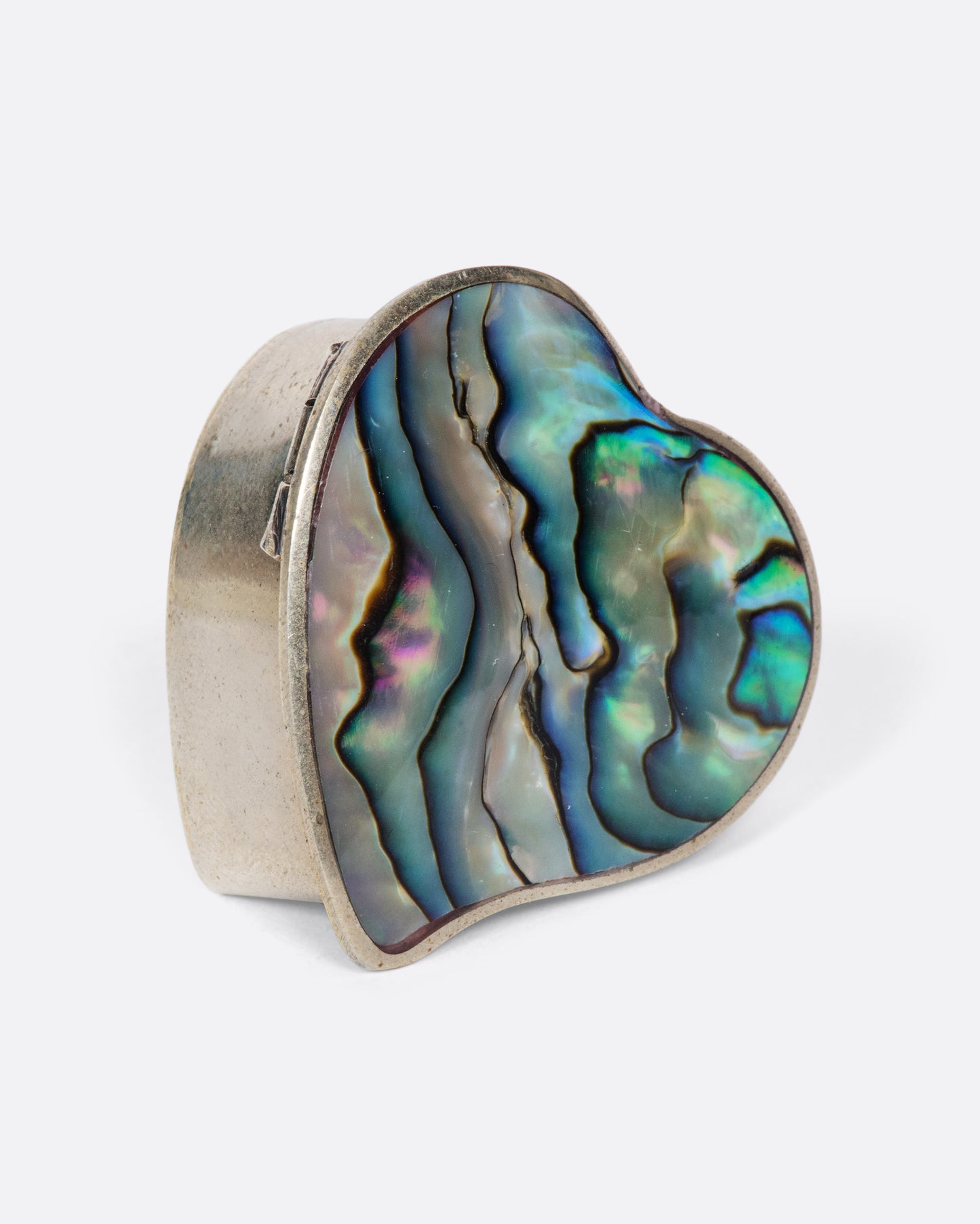 The heart-shaped abalone shell inlaid in this beautiful vintage box always makes us smile and think of the beach.