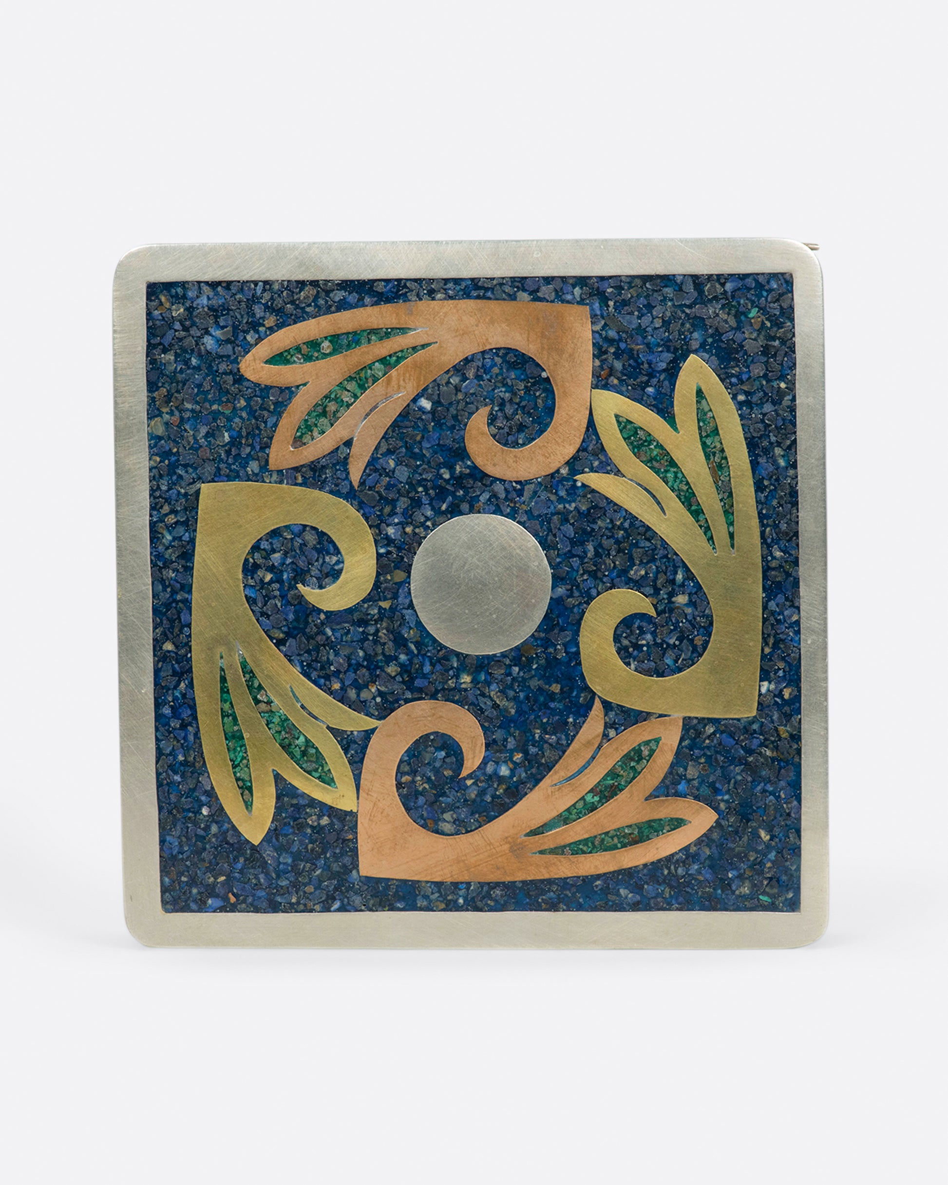 A Mexican, hinged box covered in sodalite malachite inlay and lined with wood.