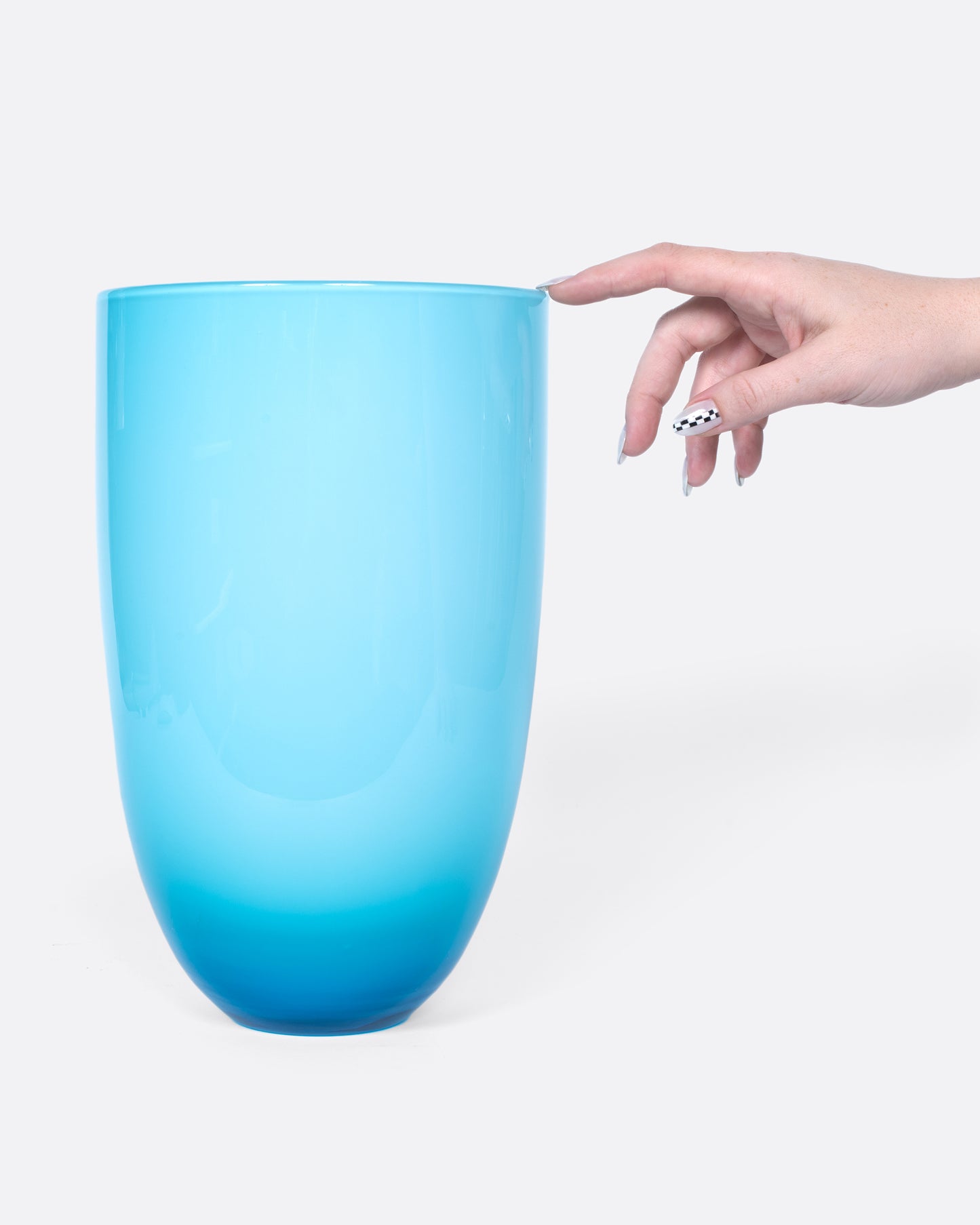 This sky blue vase has a layer of white glass on its interior to making the blue even brighter.