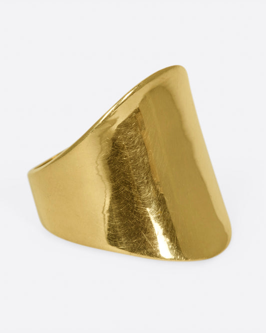 A vintage gold ring with a curved face.