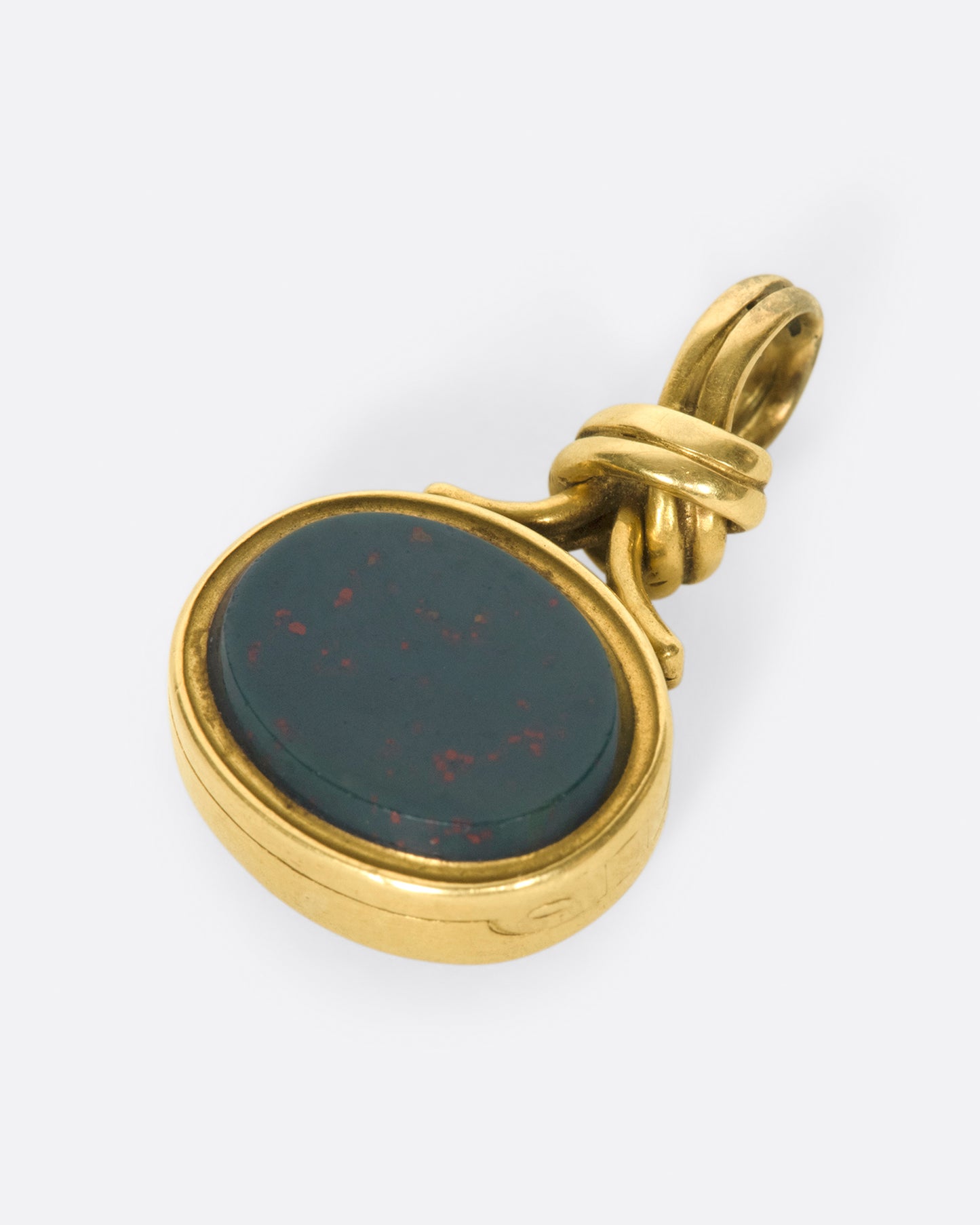 A knotted, solitaire pendant that opens up to reveal two picture framesI
