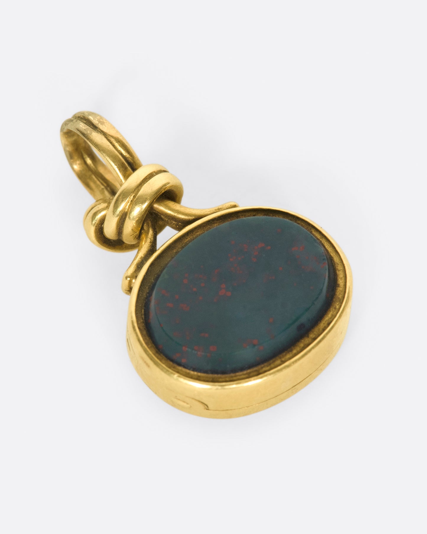 A knotted, solitaire pendant that opens up to reveal two picture framesI