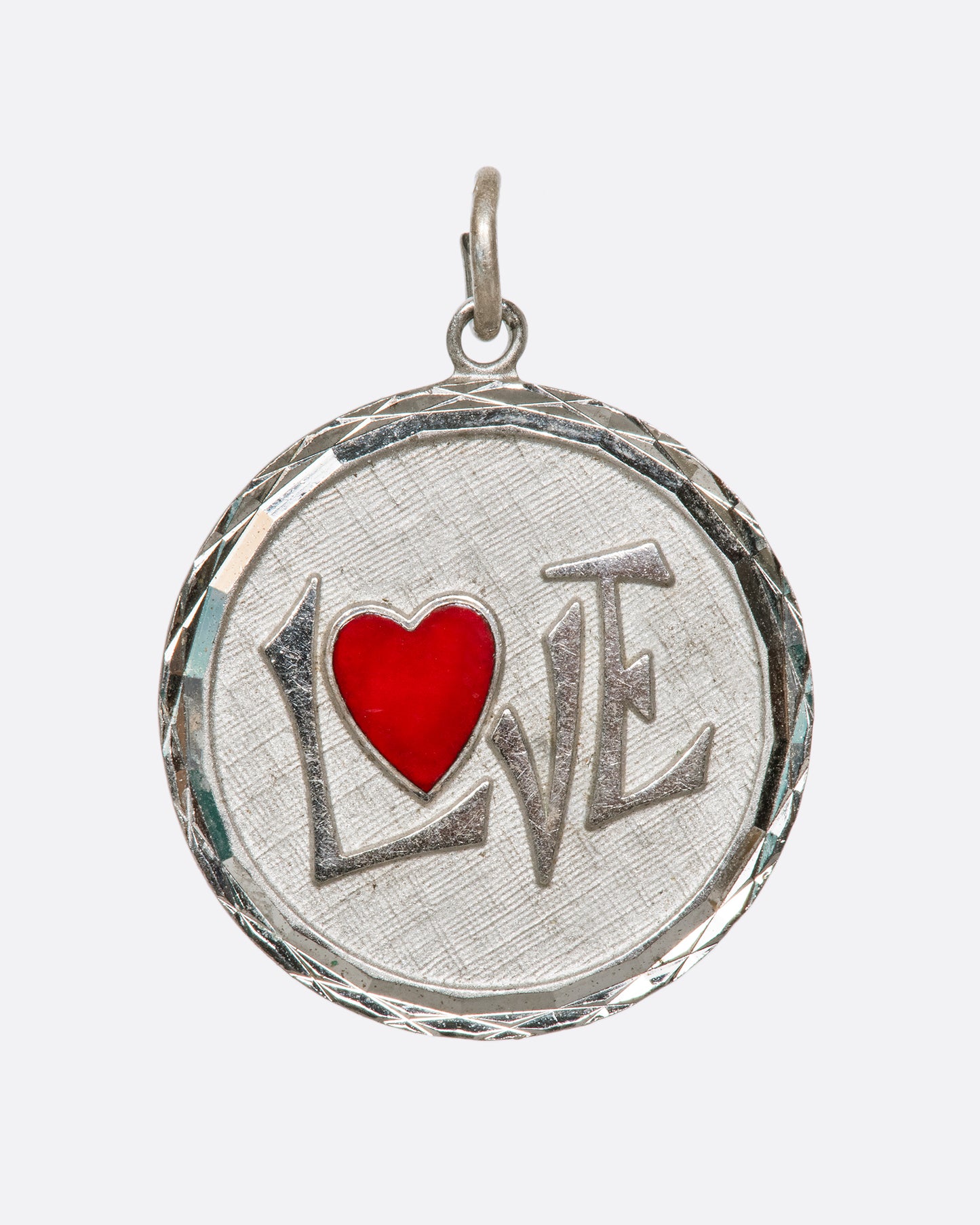 At a distance the heart speaks for this pendant, but the message is spelled out up close.