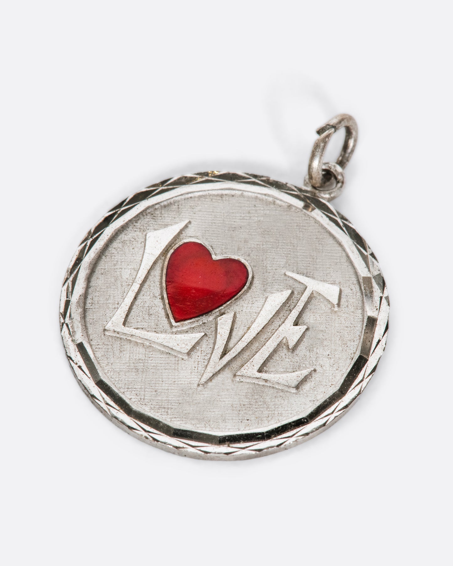 At a distance the heart speaks for this pendant, but the message is spelled out up close.