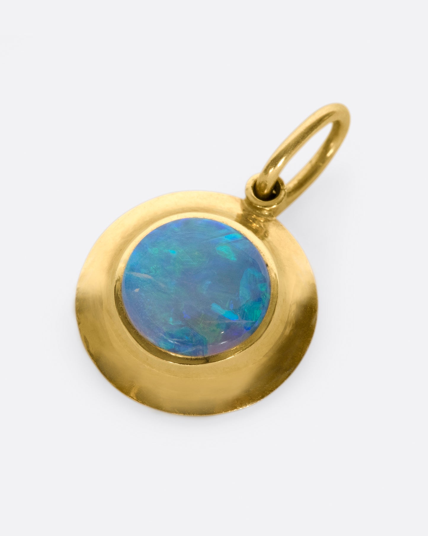 A hefty solitaire pendant with a flashy, bezel set opal.
