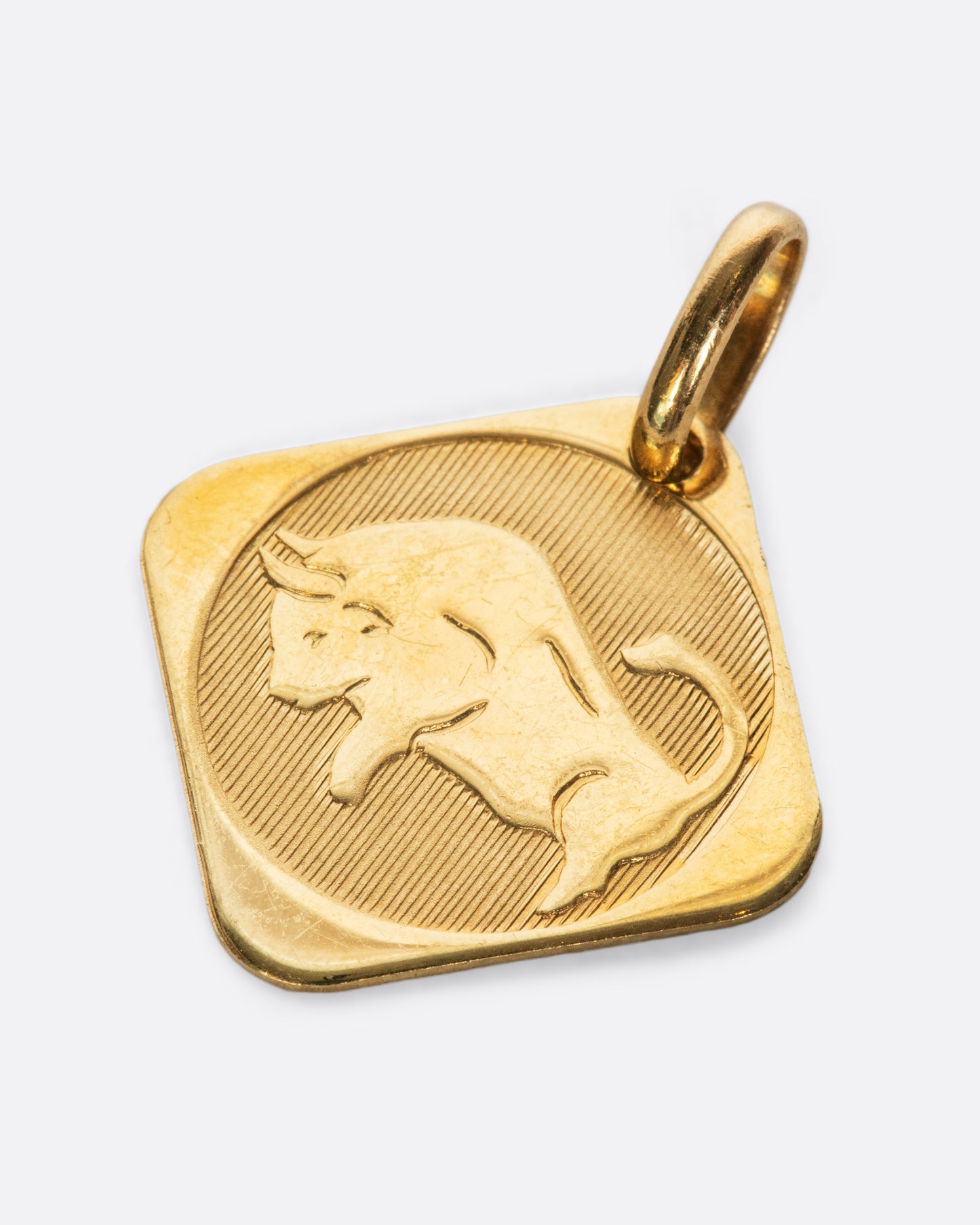 A square, polished pendant, hung by one of its corners.