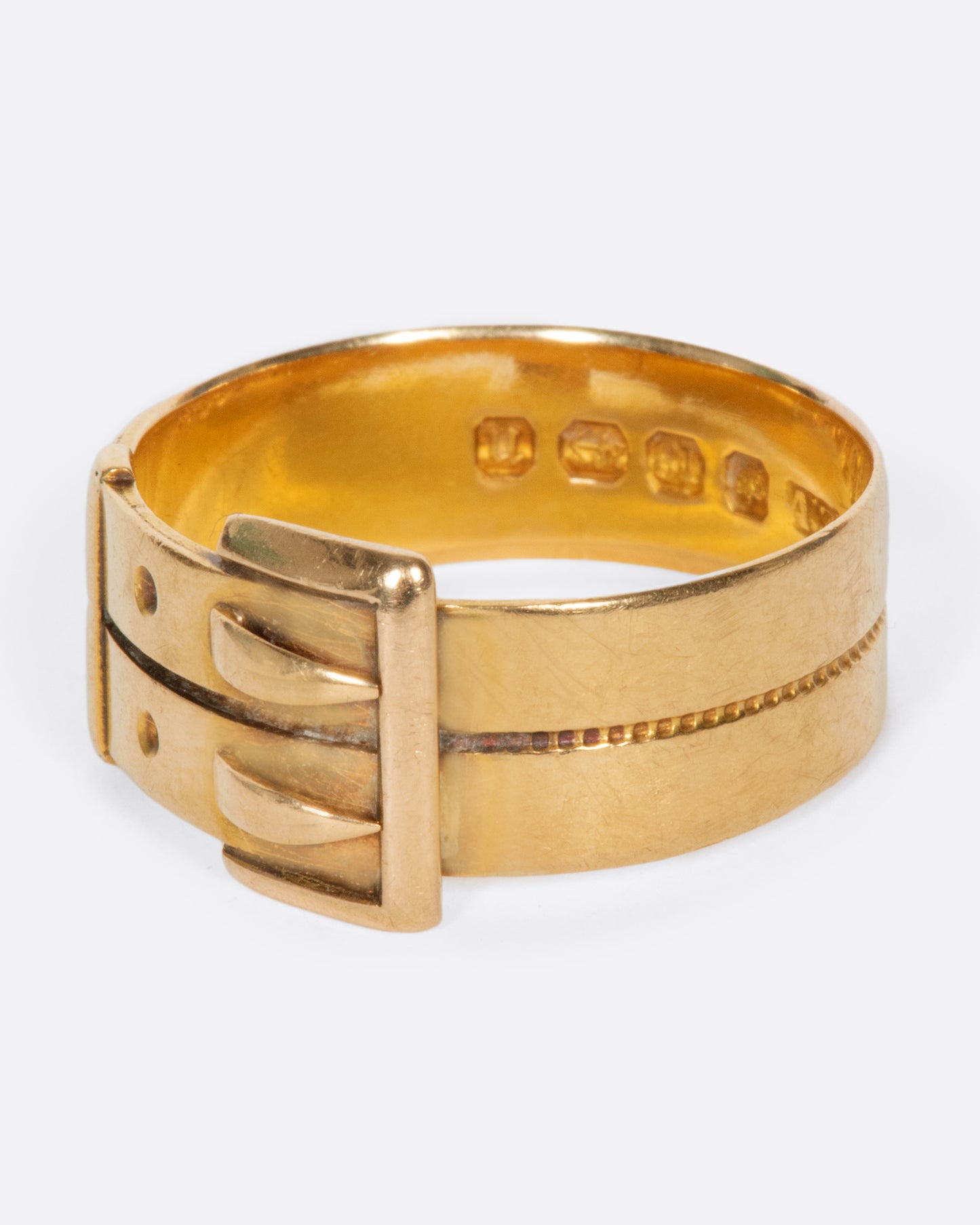 A vintage yellow gold belt buckle ring with two buckles.