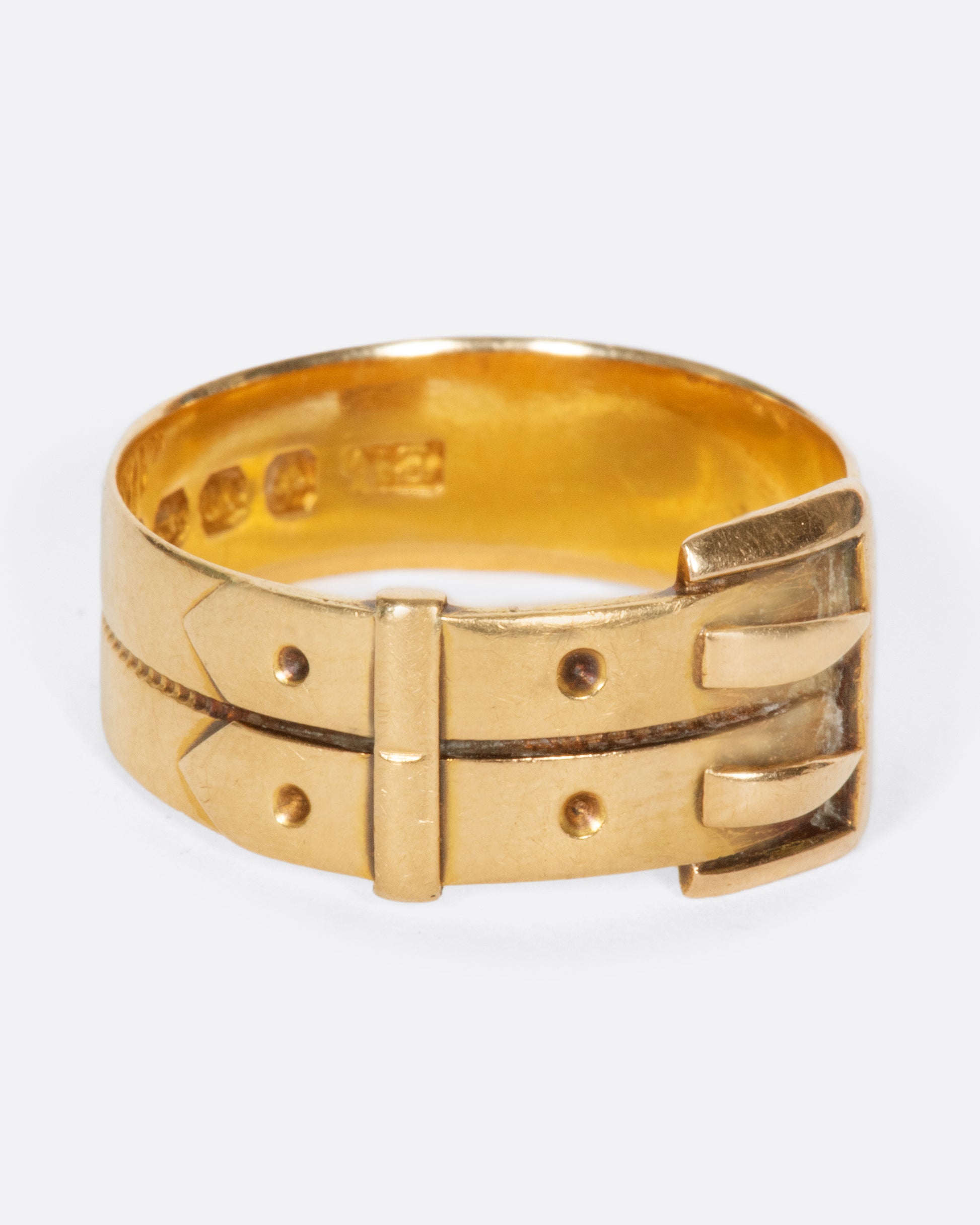 A vintage yellow gold belt buckle ring with two buckles.