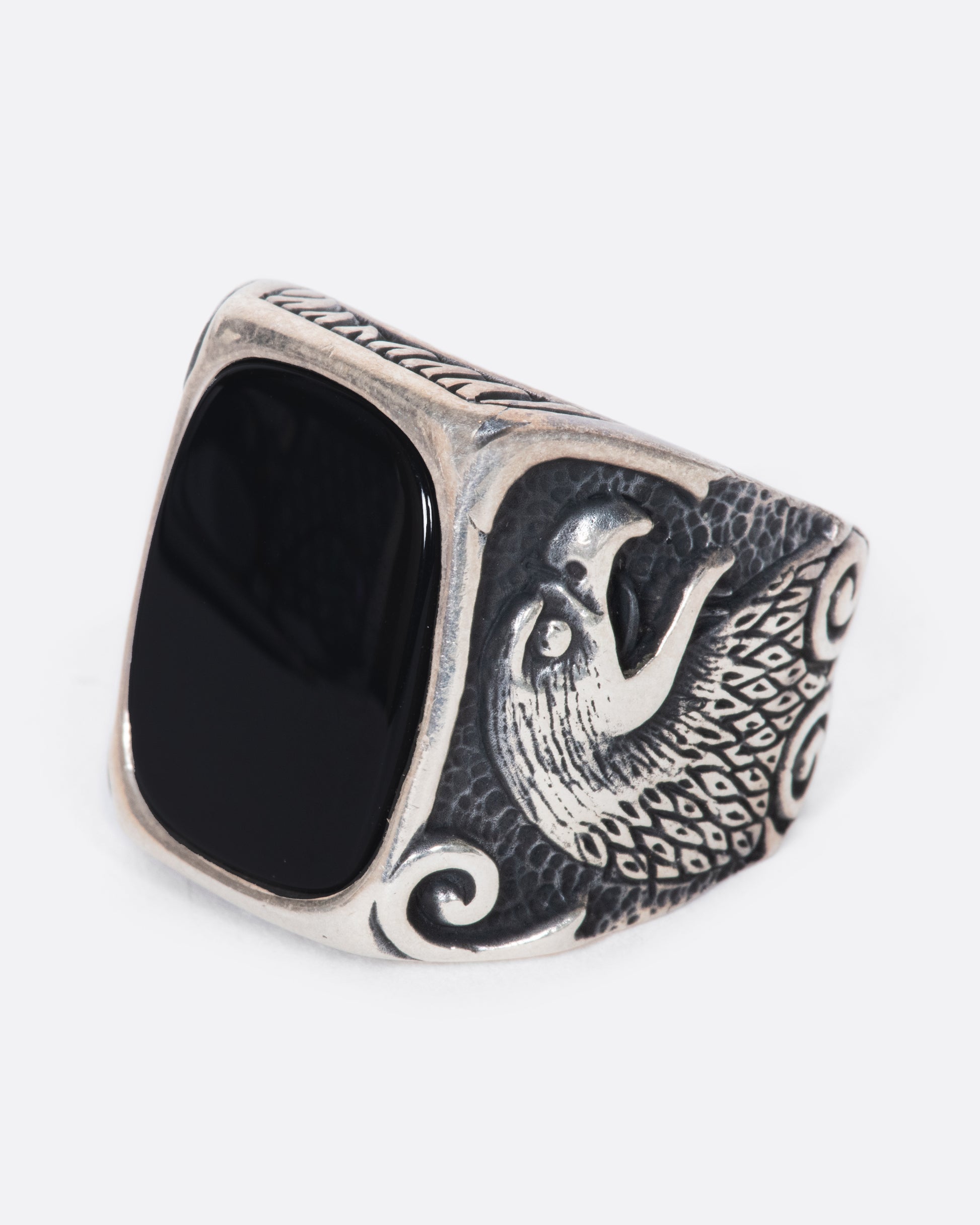 A fierce onyx signet ring with two eagles guarding perched on its shoulders. 