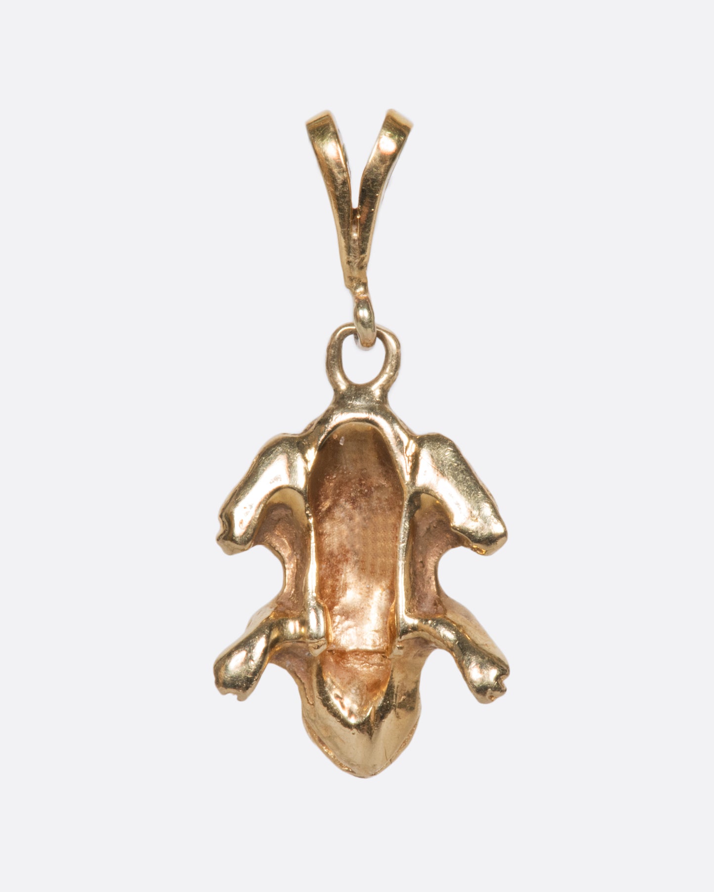 A yellow gold vintage frog charm with incredible detail and texture.