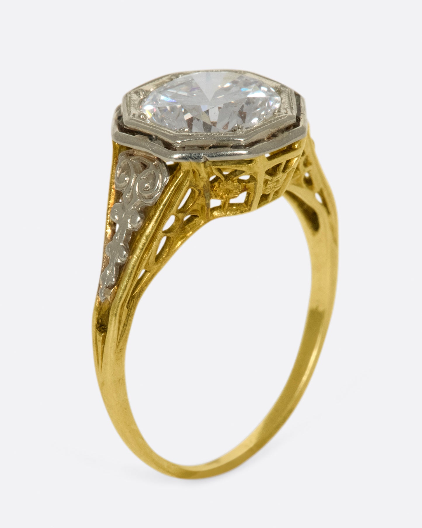 Mixed metals, intricate setting, large diamond; the ultimate vintage engagement ring.