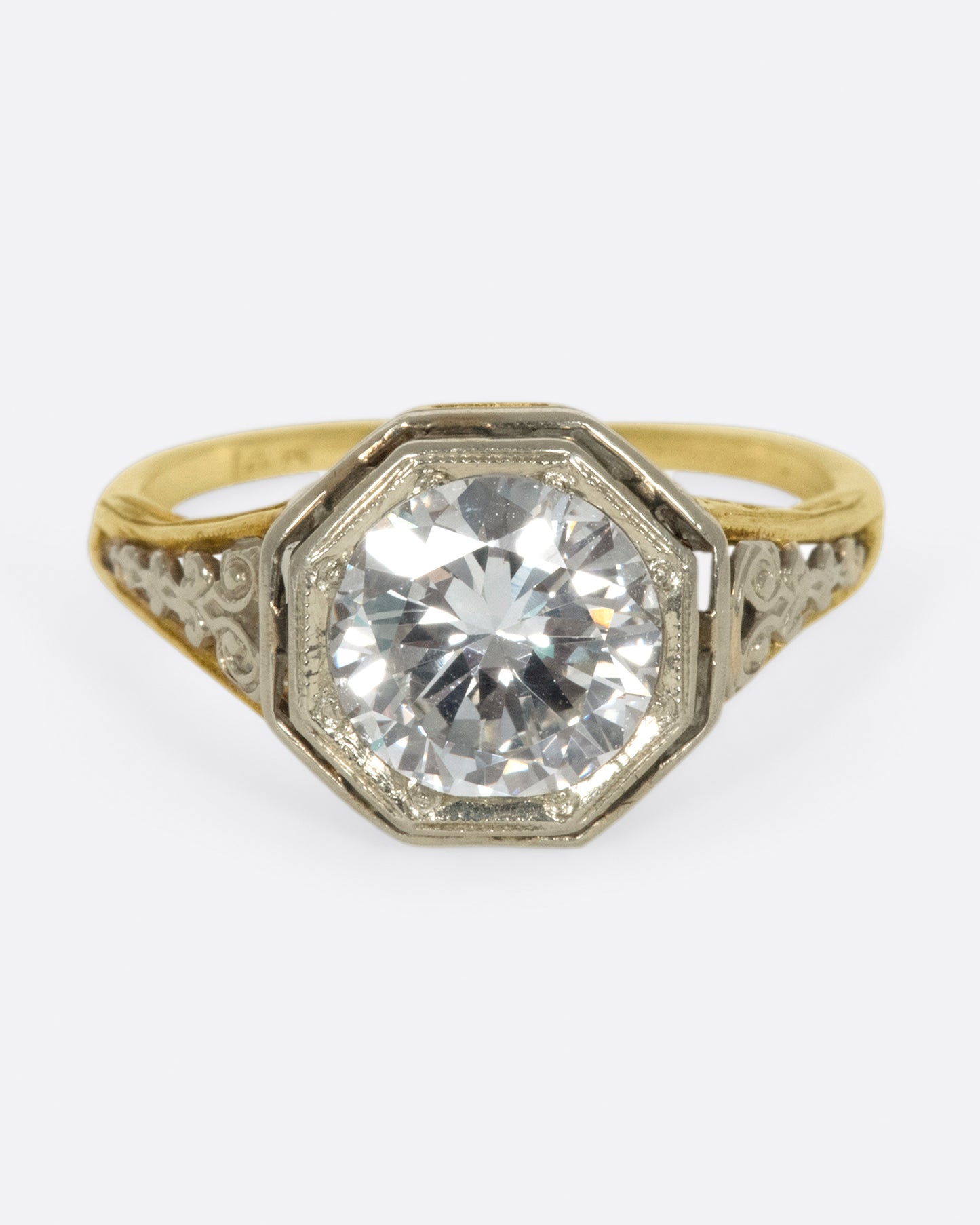 Mixed metals, intricate setting, large diamond; the ultimate vintage engagement ring.