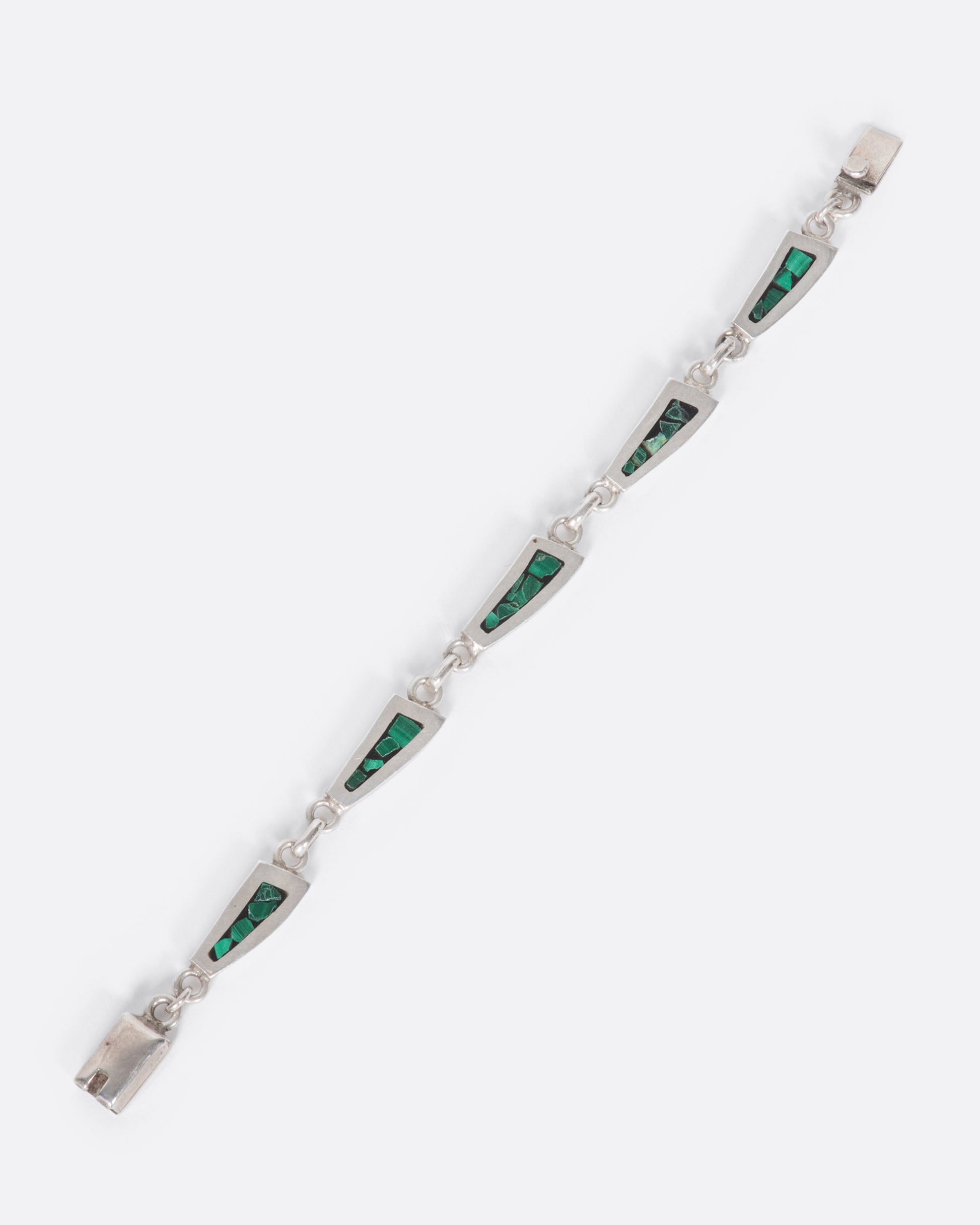 A sterling silver chain bracelet with long, trapezoidal links, lined with malachite inlay.