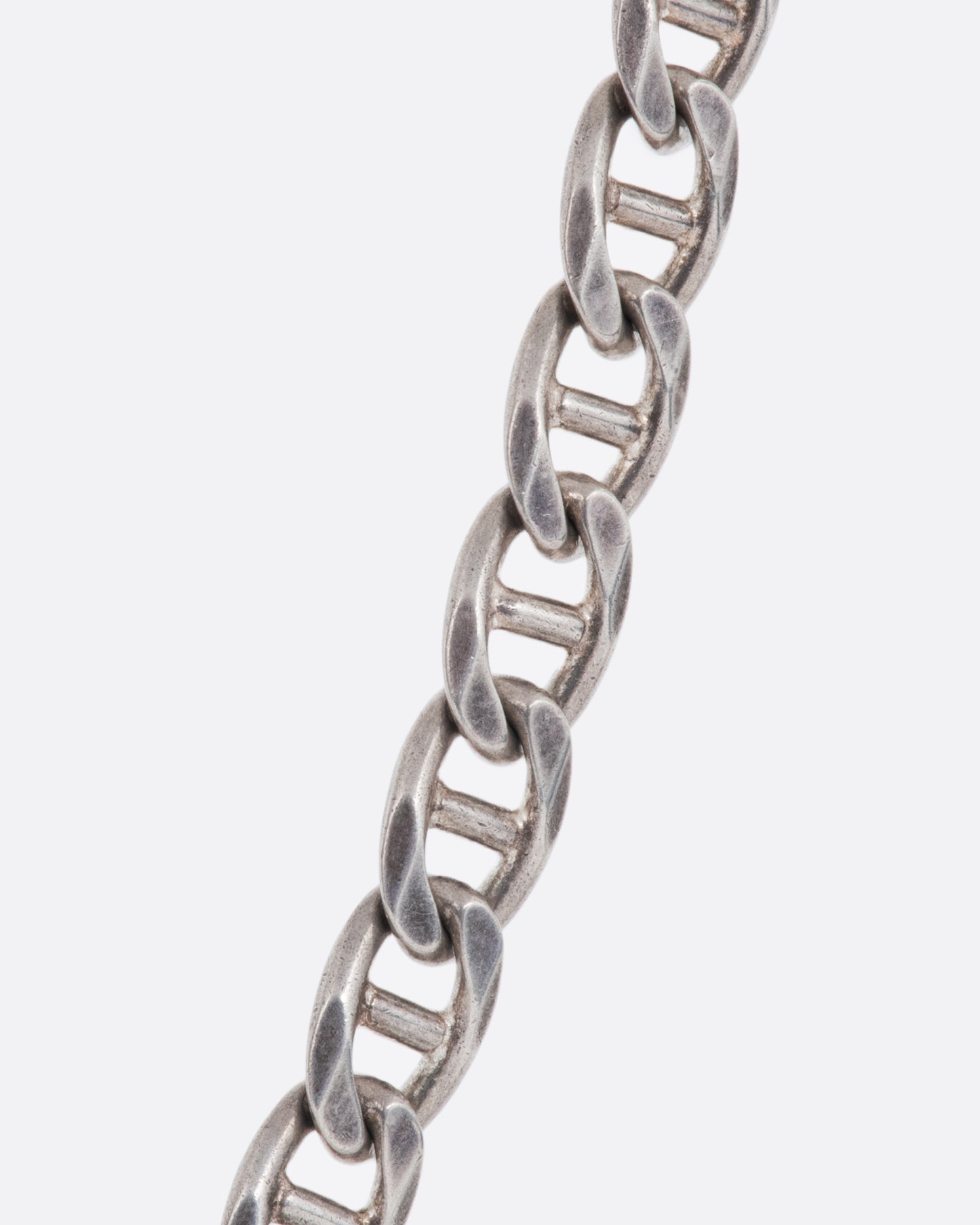 A vintage sterling silver flat mariner chain necklace - shown close up.