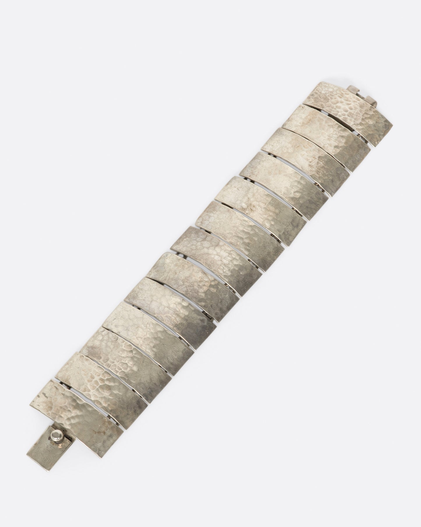 These curved pieces are connected vertically to give the illusion of a cuff bracelet.