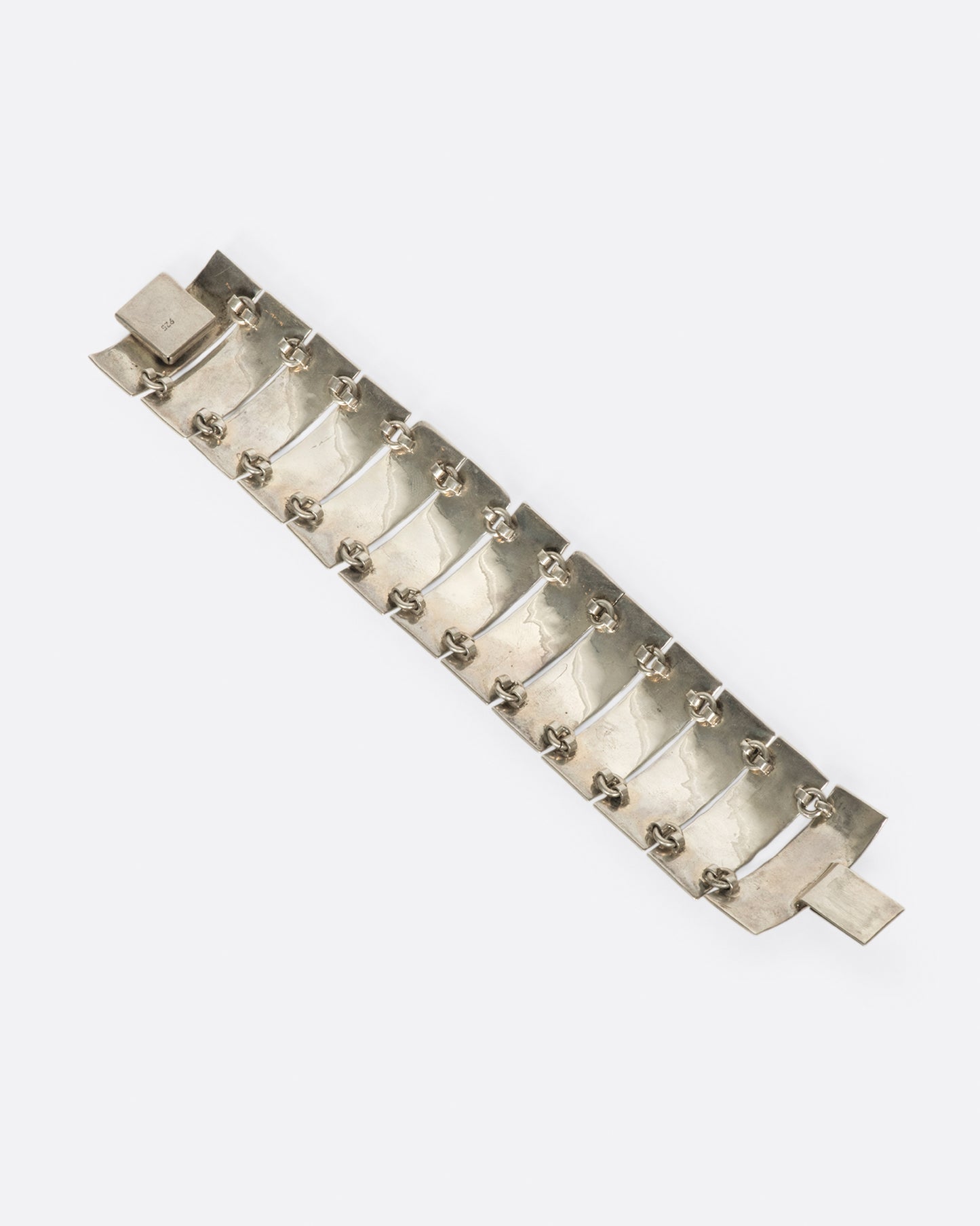 These curved pieces are connected vertically to give the illusion of a cuff bracelet.