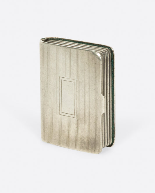 An intriguing sterling silver pill box, crafted to look like a mini book. 