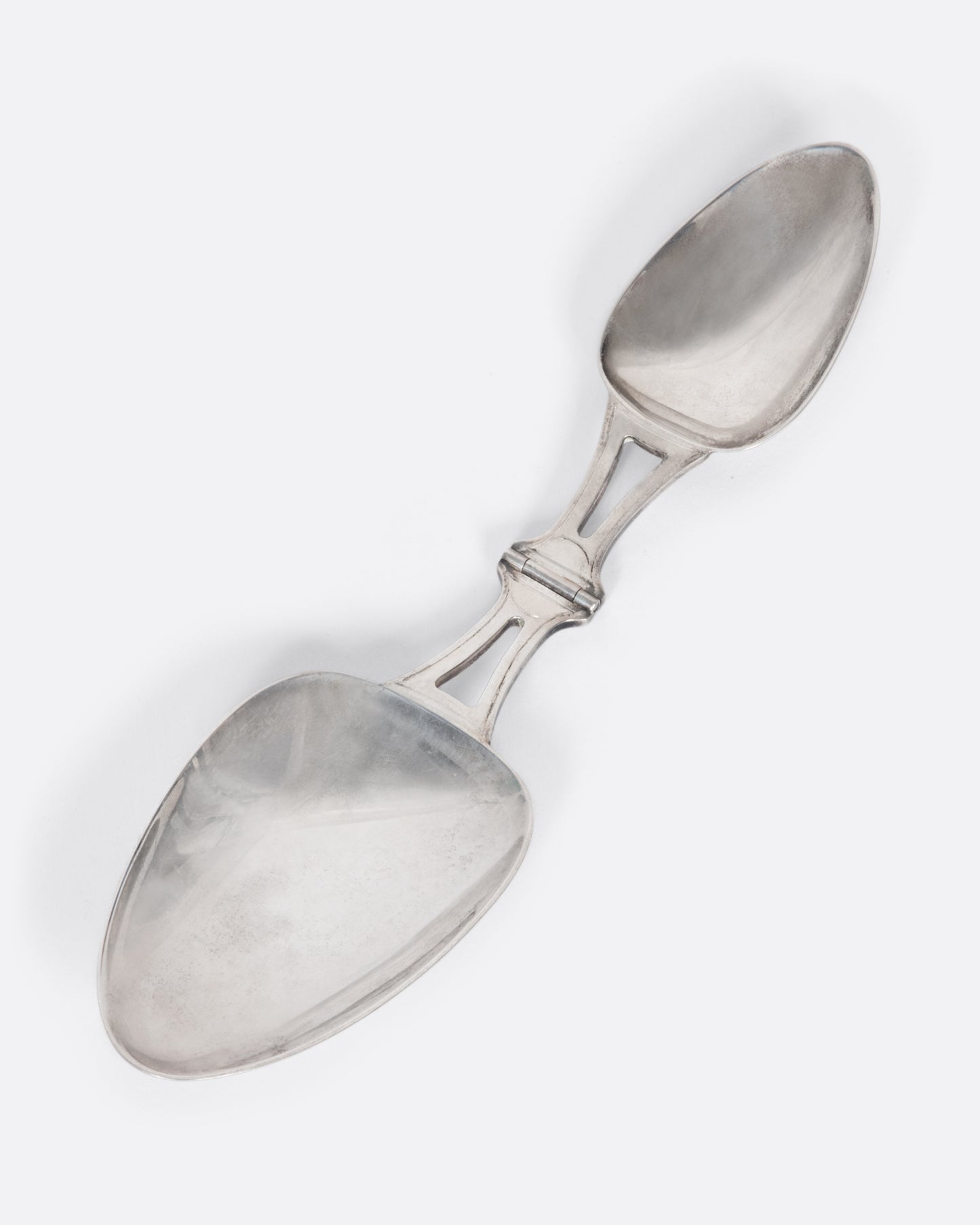 A sterling silver folding spoon with a teaspoon on one side and a tablespoon on the other.