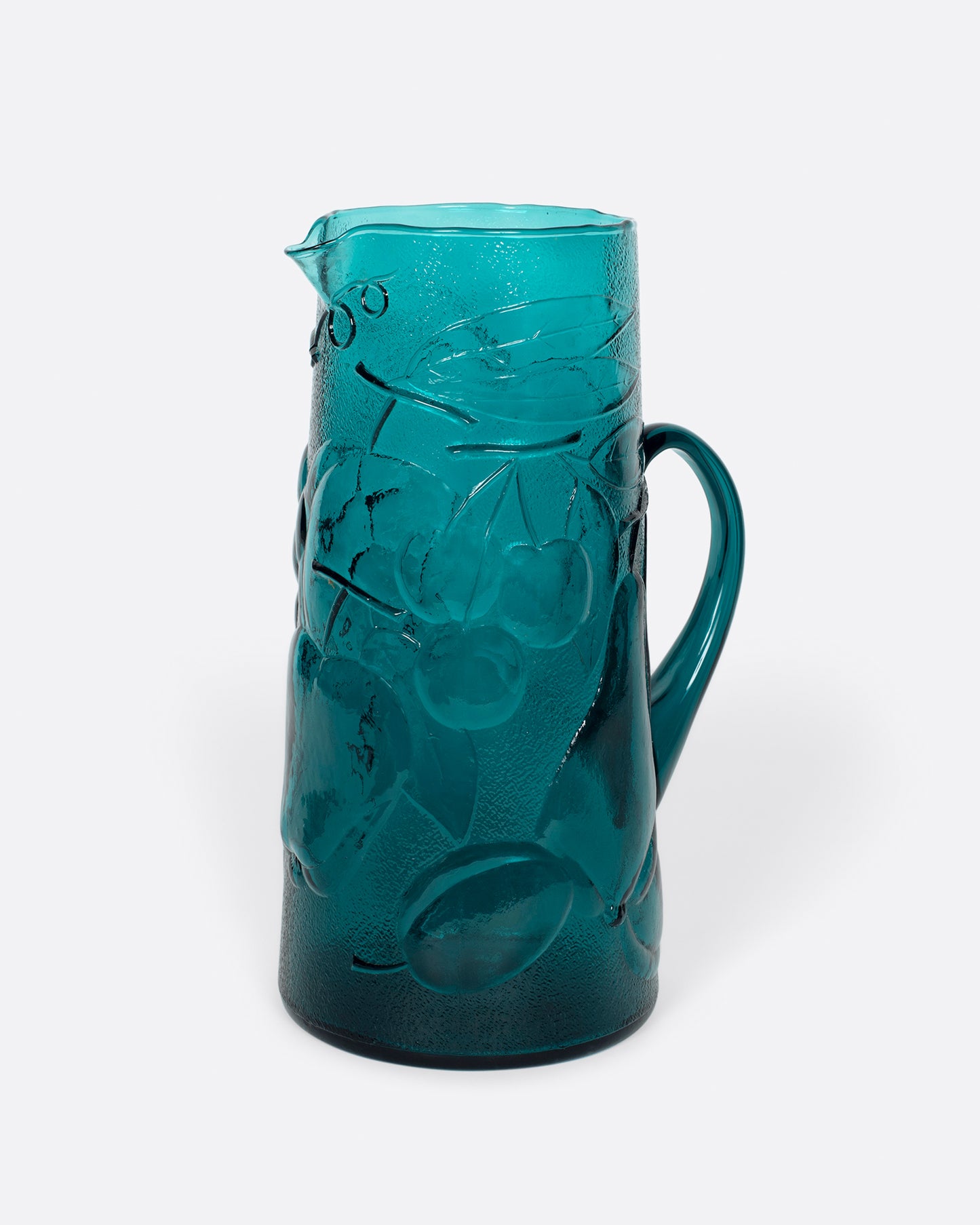 This teal glass set has a subtle fruity texture.