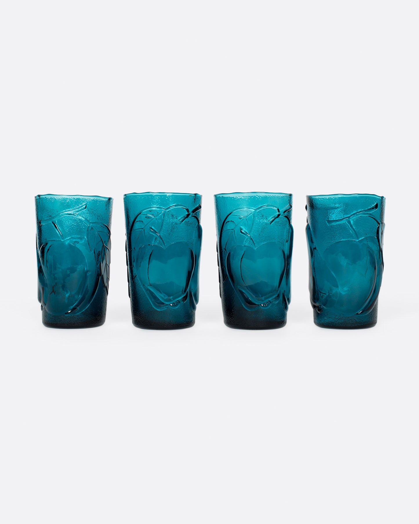 This teal glass set has a subtle fruity texture.