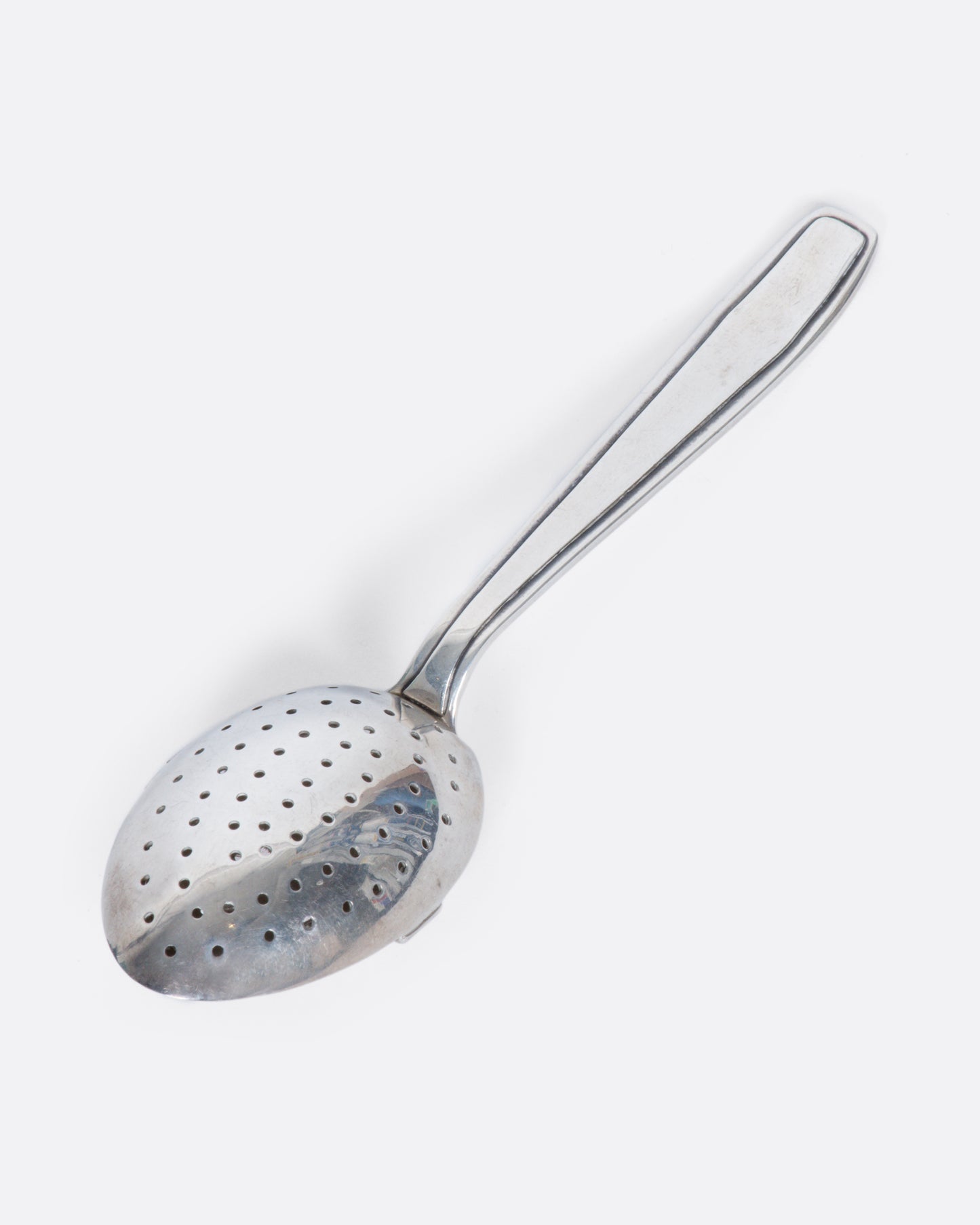 A perforated sterling silver spoon with a hinged perforated lid to create a tea diffuser.