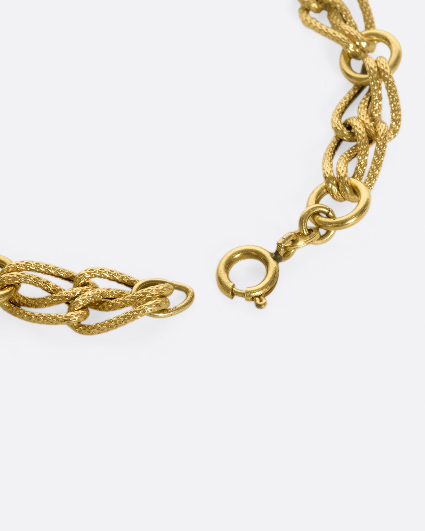 The links on this chain look like strands of gold, linked between round loops.