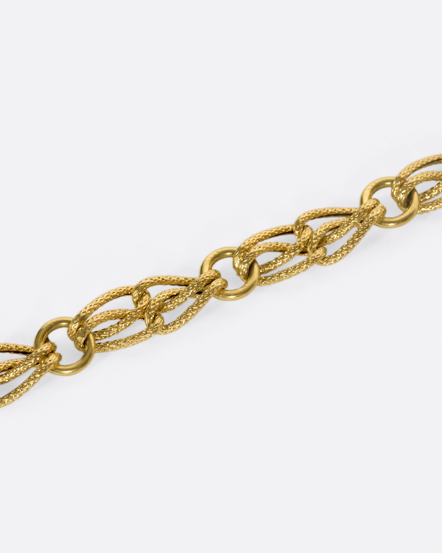 The links on this chain look like strands of gold, linked between round loops.
