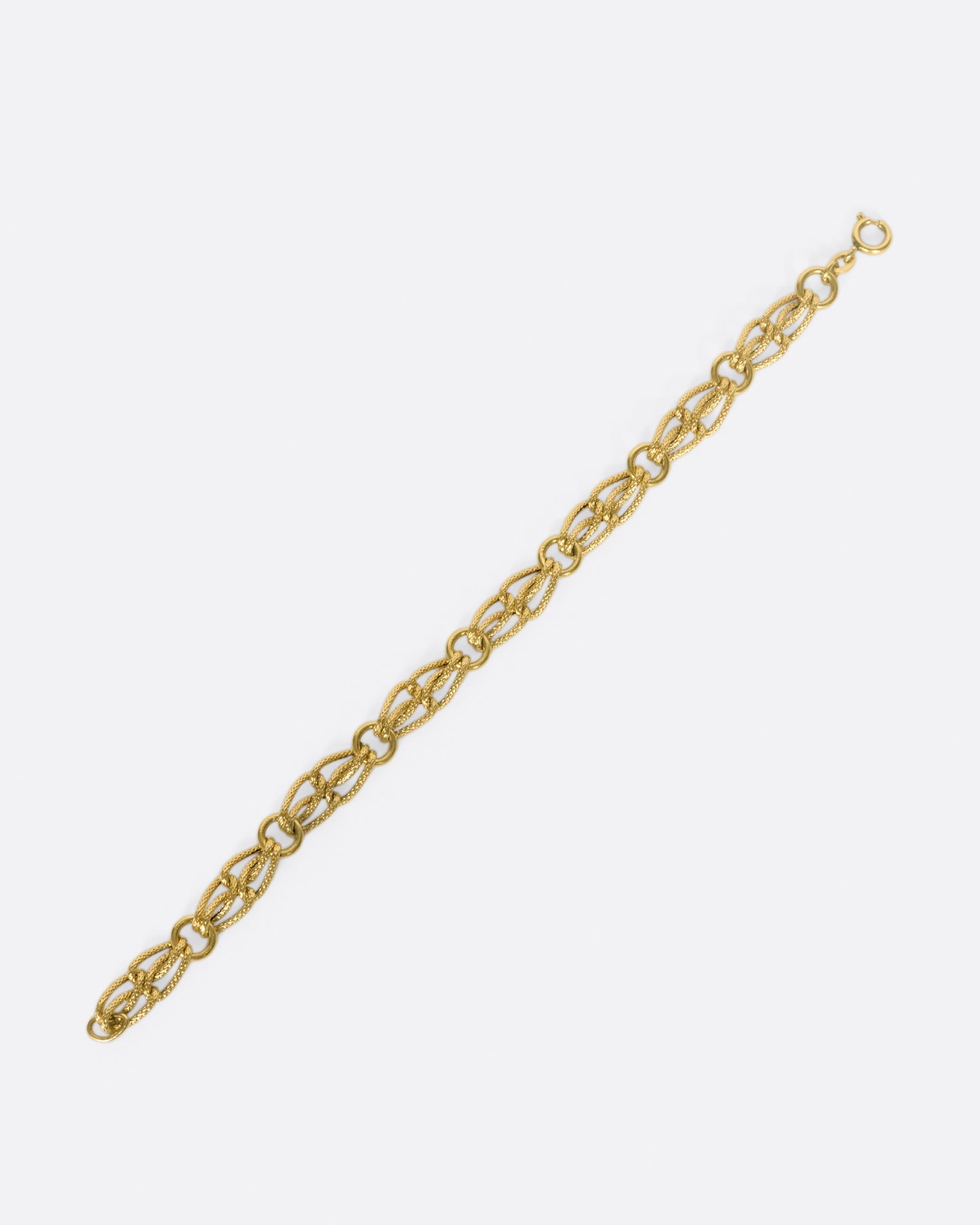 The links on this chain look like strands of gold, linked between round loops.