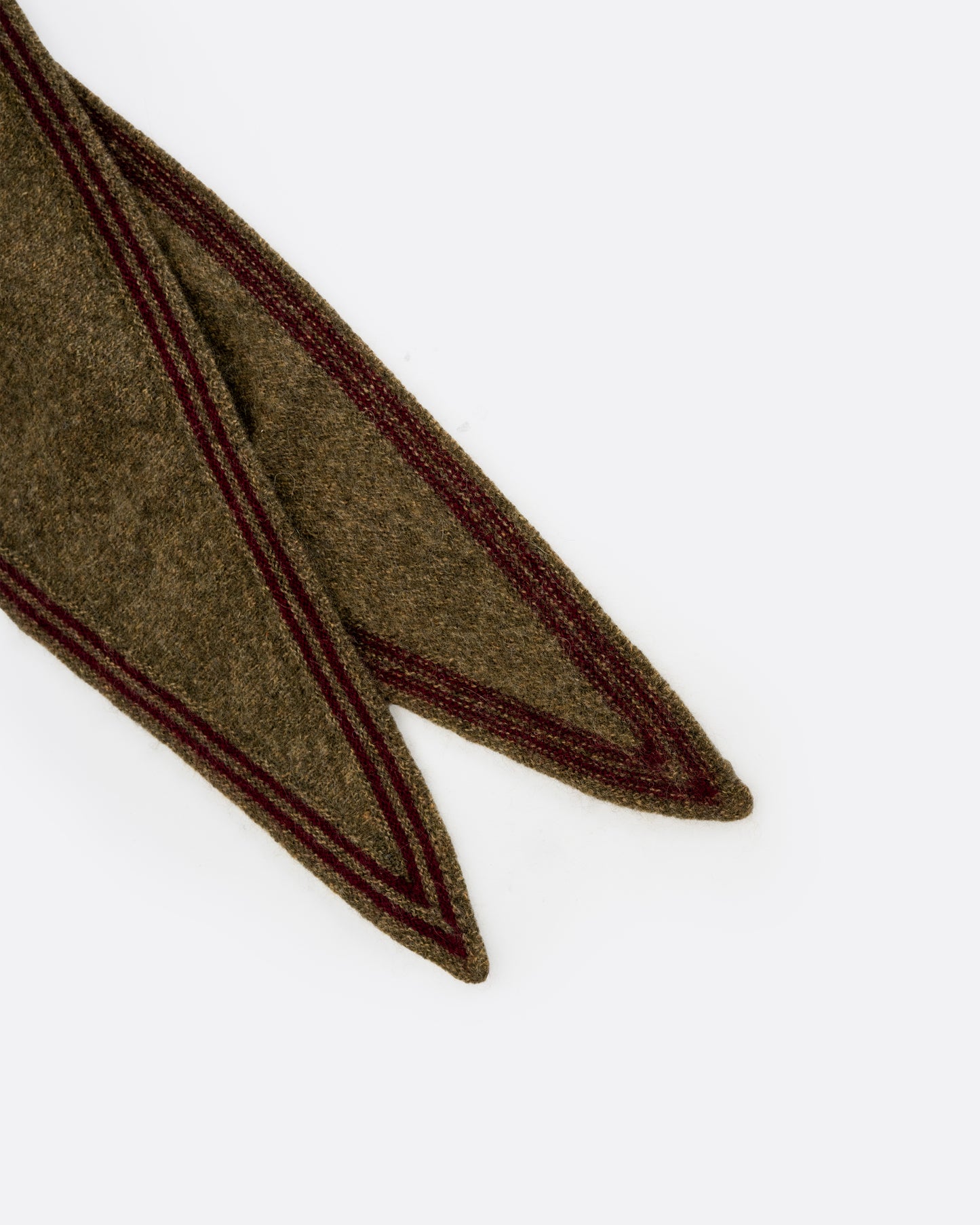 A close up of a cashmere olive green neck scarf with dark red edges.
