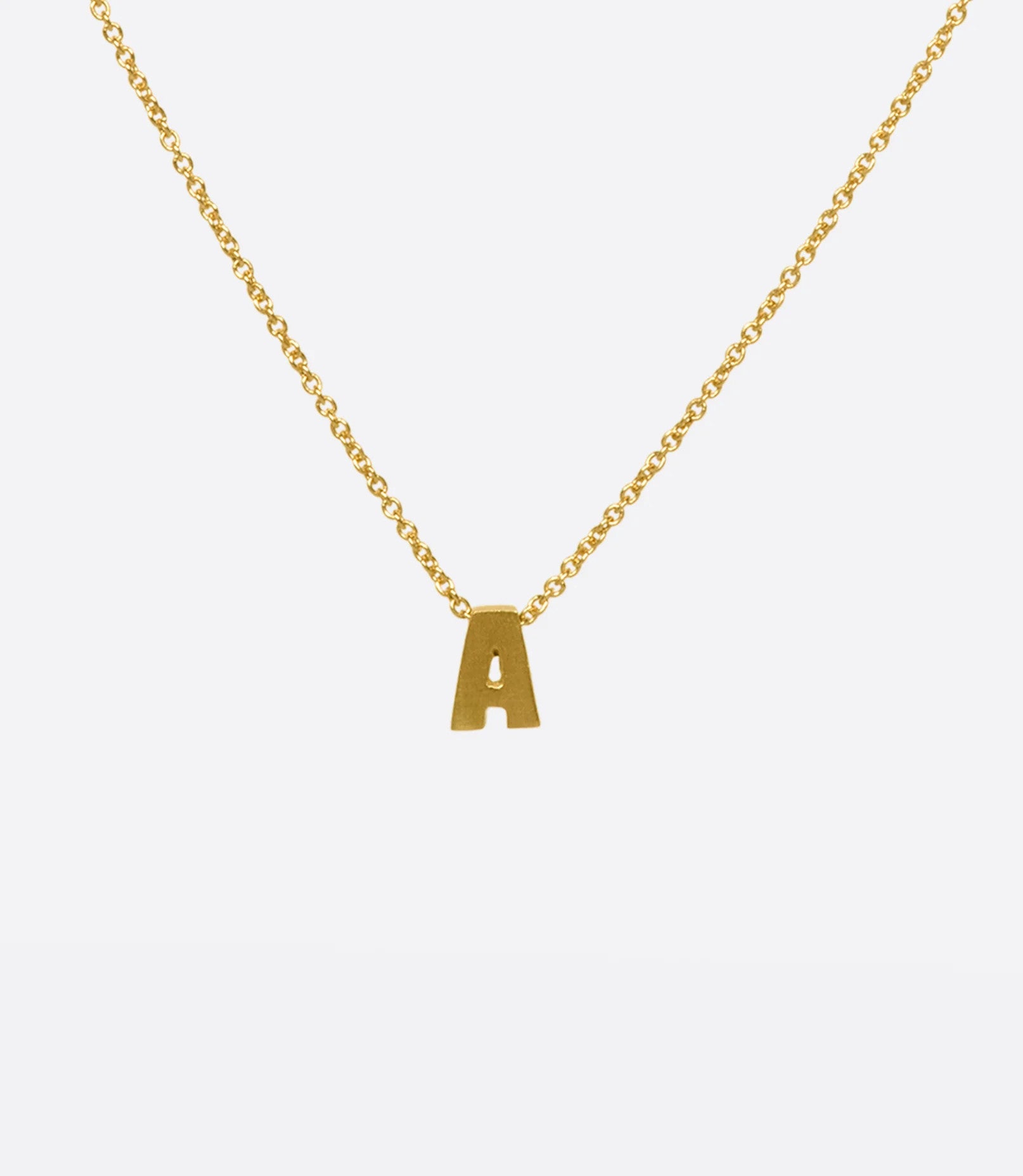 A yellow gold cable chain necklace with a letter A initial pendant. Shown from the front.