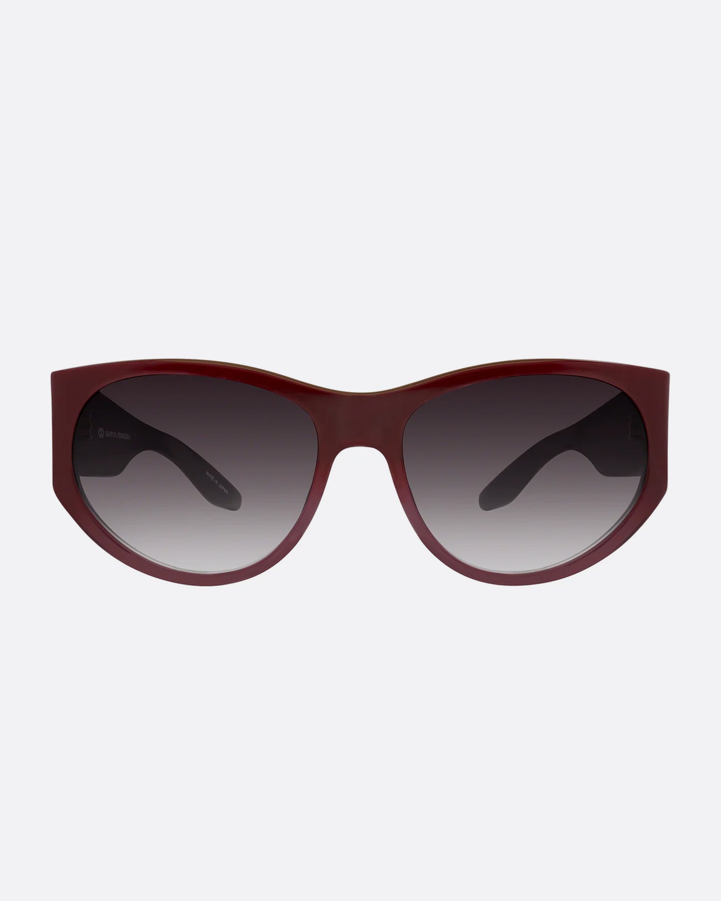 A pair of burgundy sunglasses with gradient lenses. Shown from the front.
